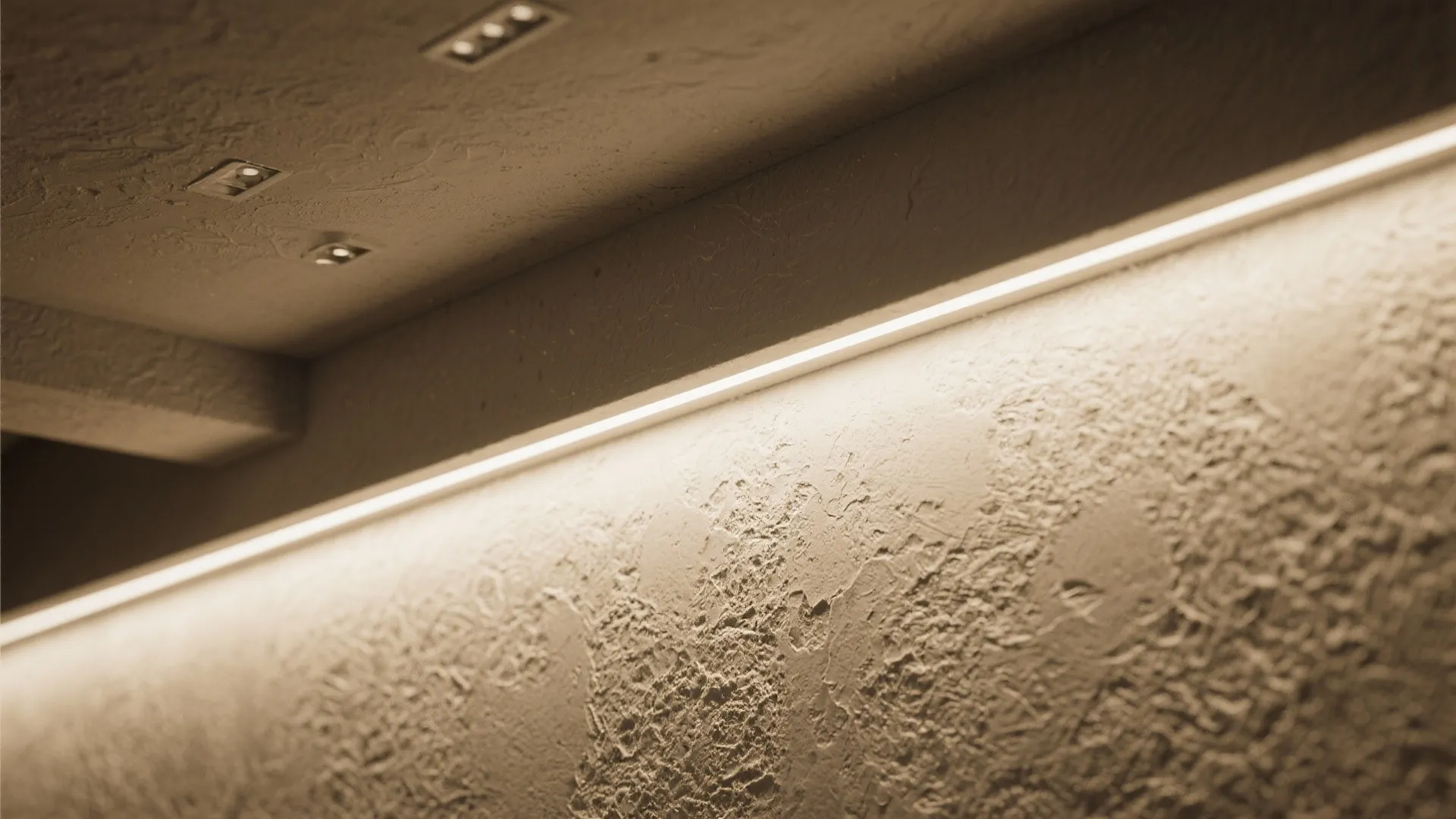 Textured plaster wall highlighted by narrow-beam wall grazing lights emphasizing depth