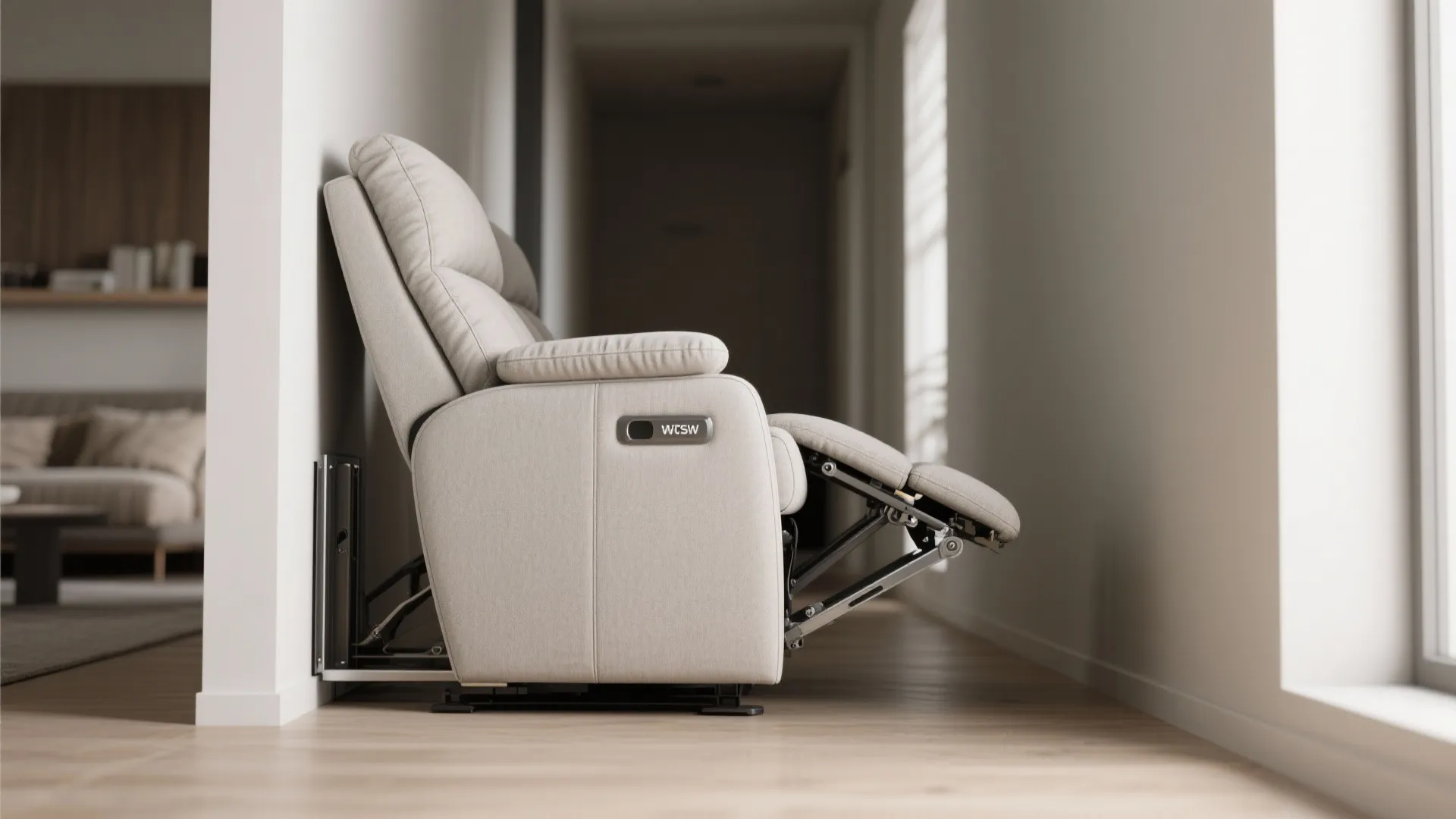 Side view of a white sofa chair with a footrest extending outward next to a wall