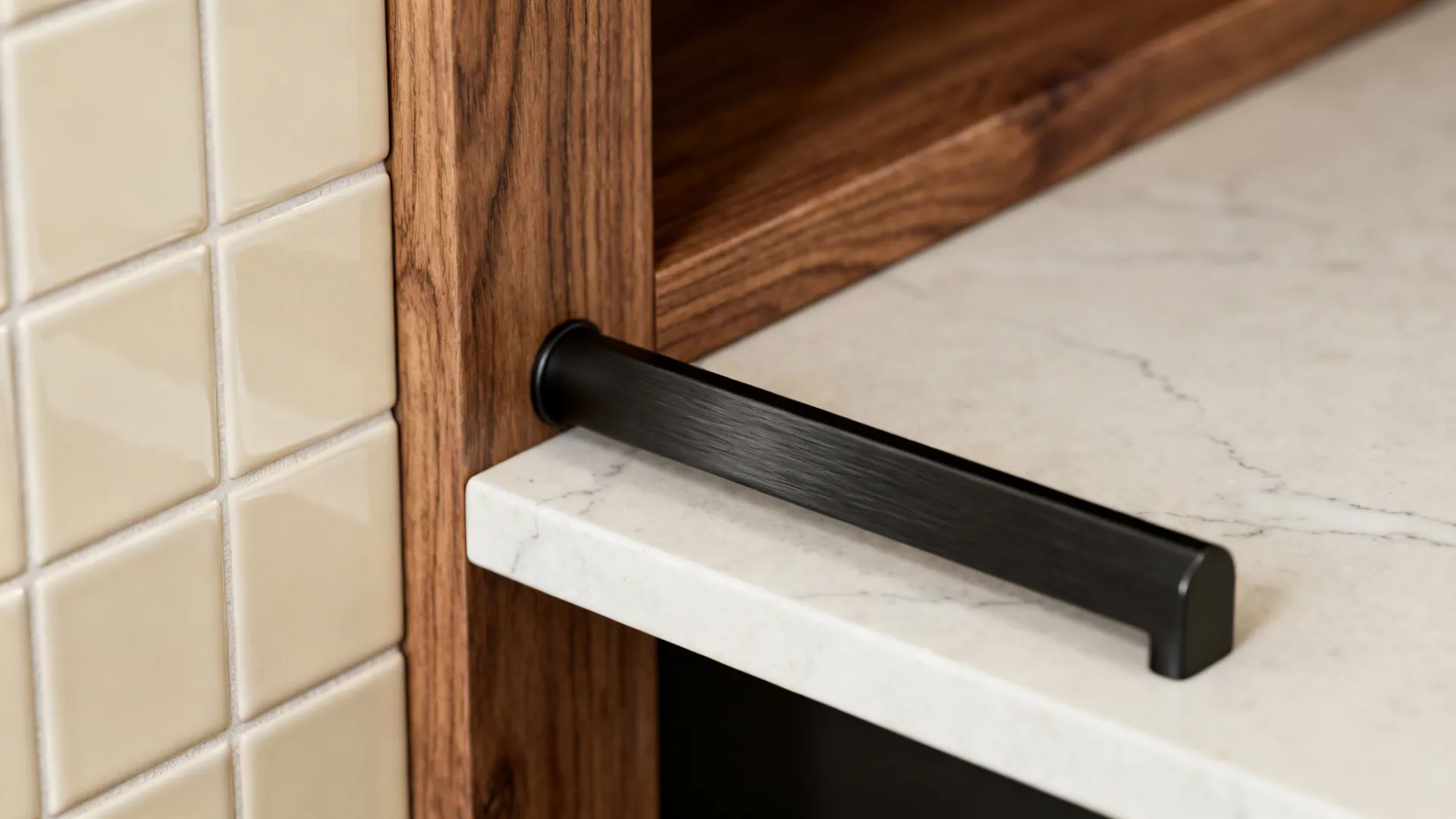 Black long handle on marble surface next to dark wood cabinet and cream wall tiles