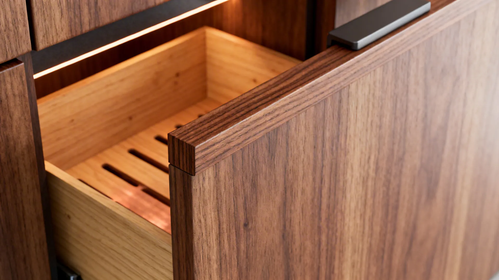 Macro of walnut veneer edge-banding and cedar insert for ventilated copperware storage.