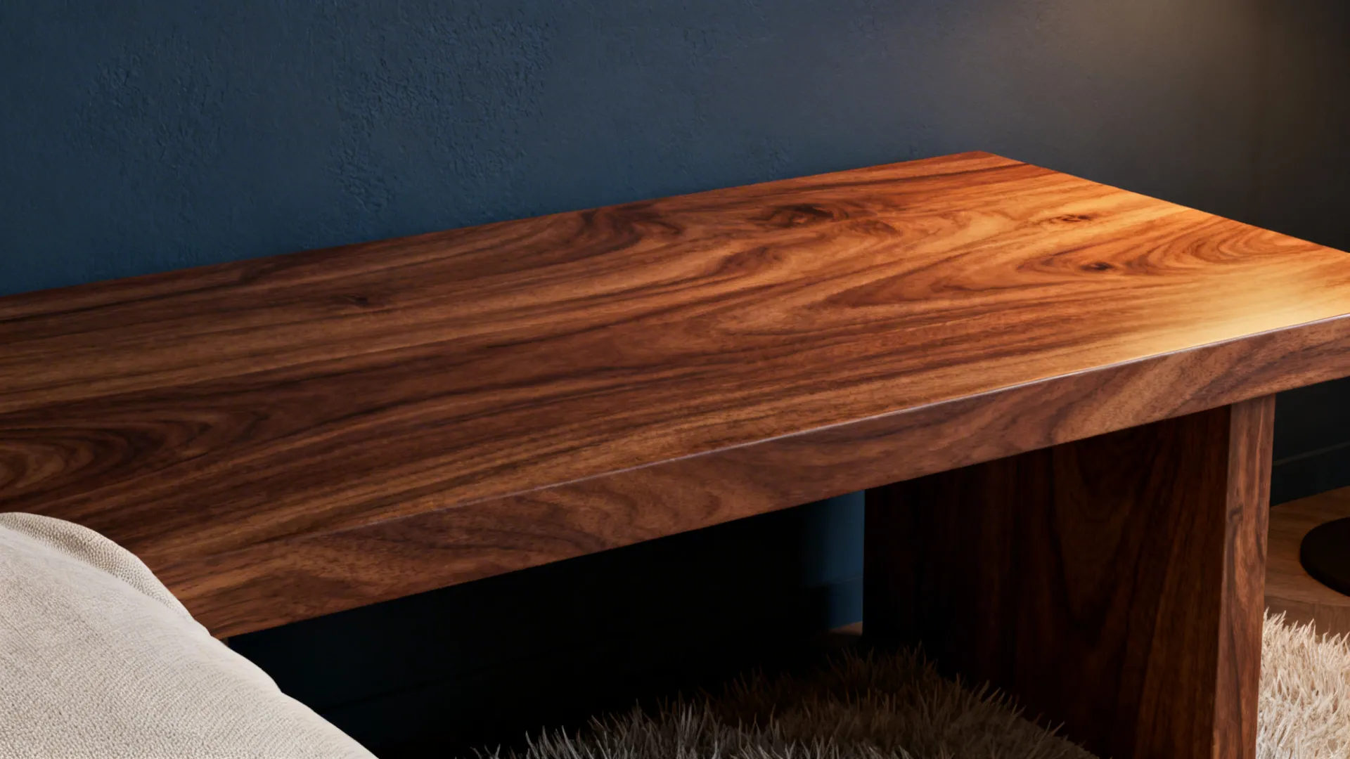 Close up of a dark wood table with natural grain against a navy blue wall