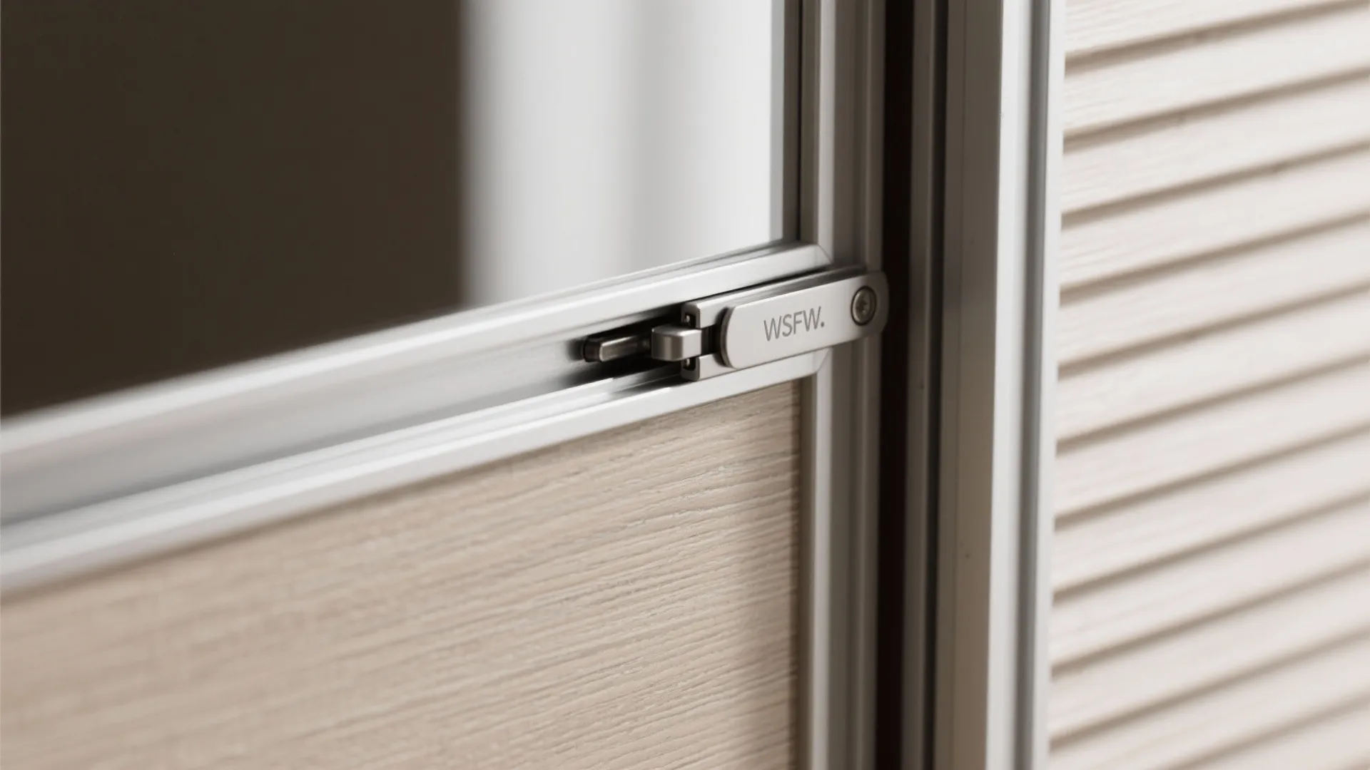 Macro of sliding wardrobe track and soft-close hinge with veneer and mirror.