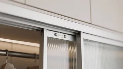 Modern Walk-In Closet with Frosted Glass Sliding Doors