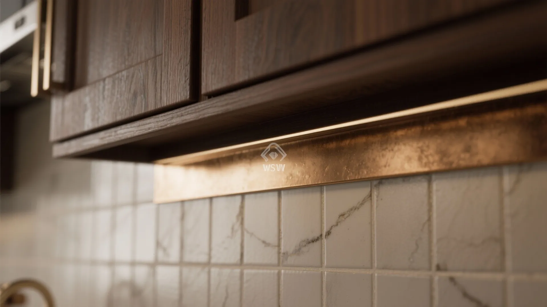 Dark wood kitchen cabinets with warm light strip shining on a gold metal wall panel