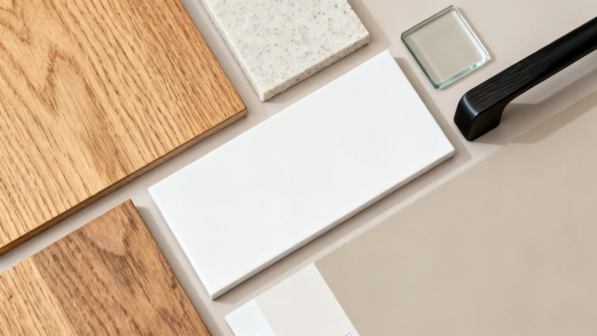 Interior design materials including wood samples white tiles stone pieces and black door handle on surface