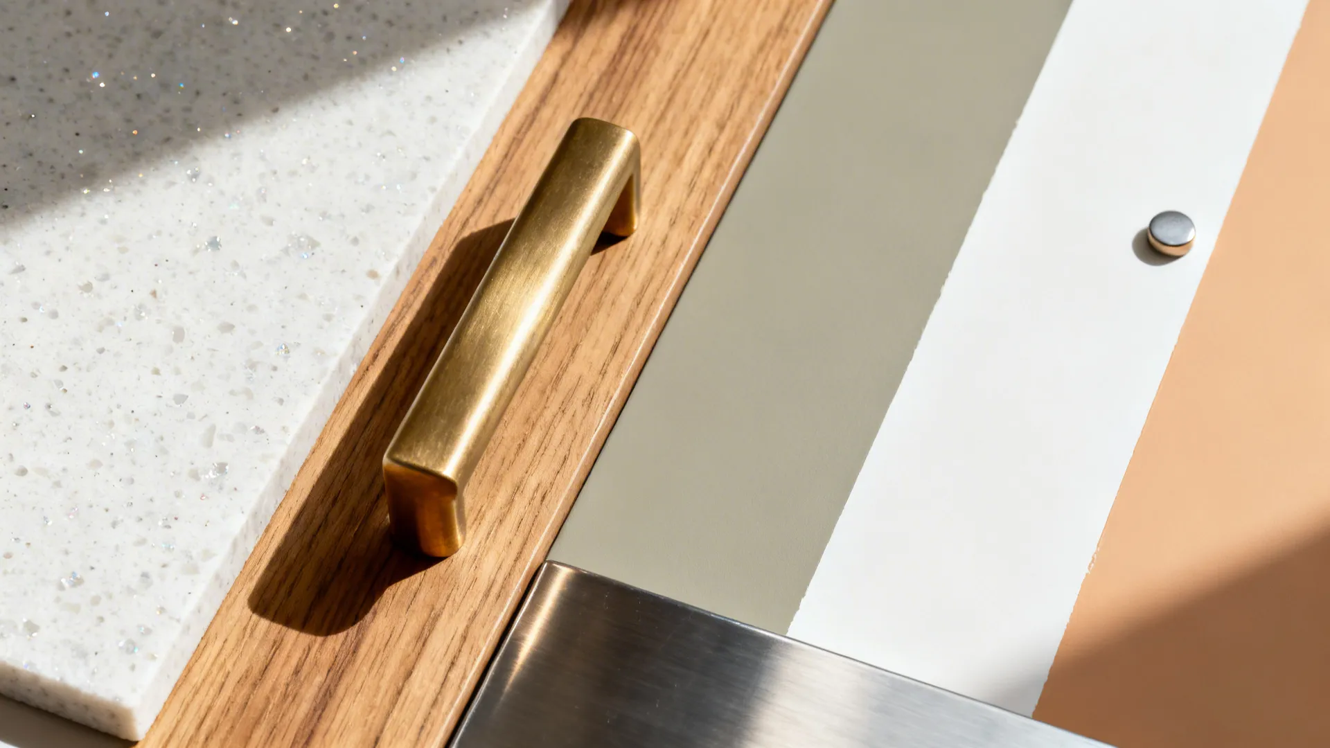 Flat lay of white quartz, rift oak, brass hardware, and soft neutral paint swatches.
