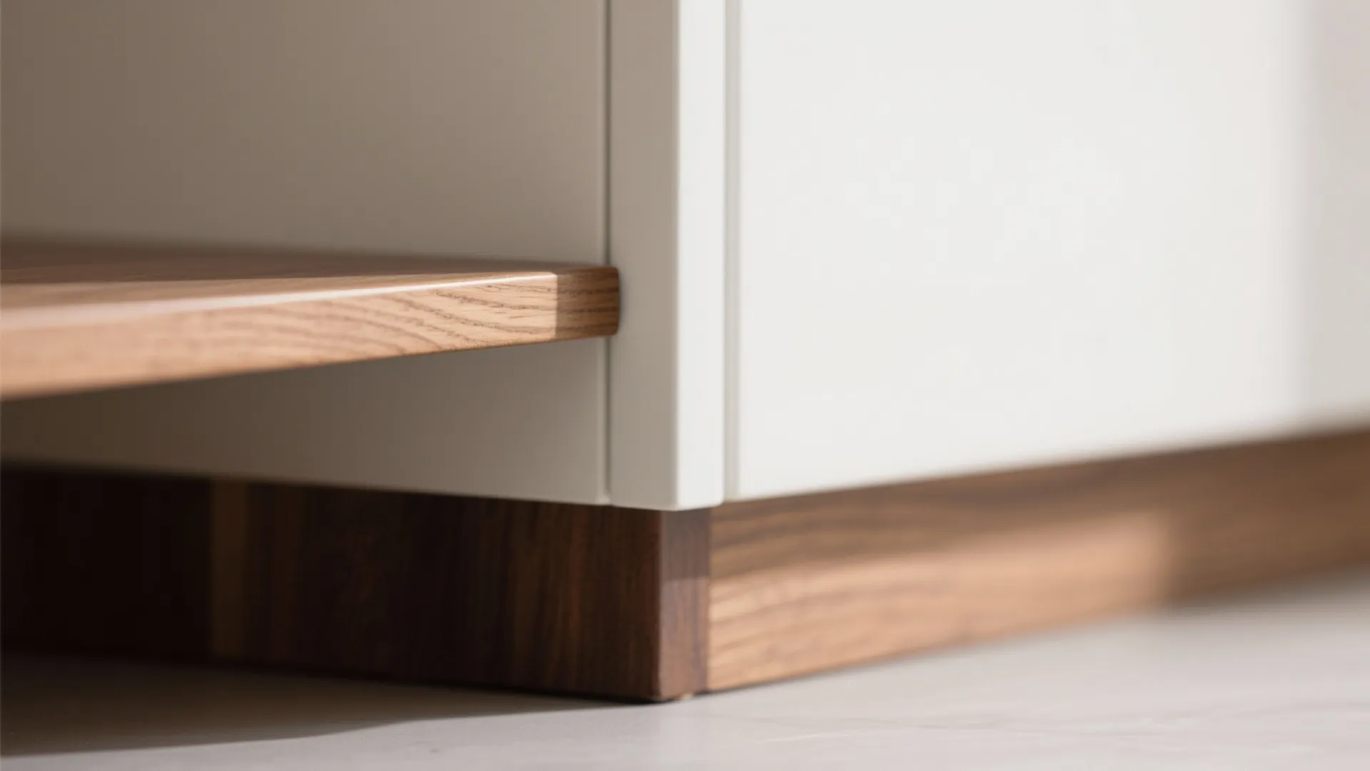 Close up view of high quality wood shelf joined to white cabinet showing detailed furniture construction
