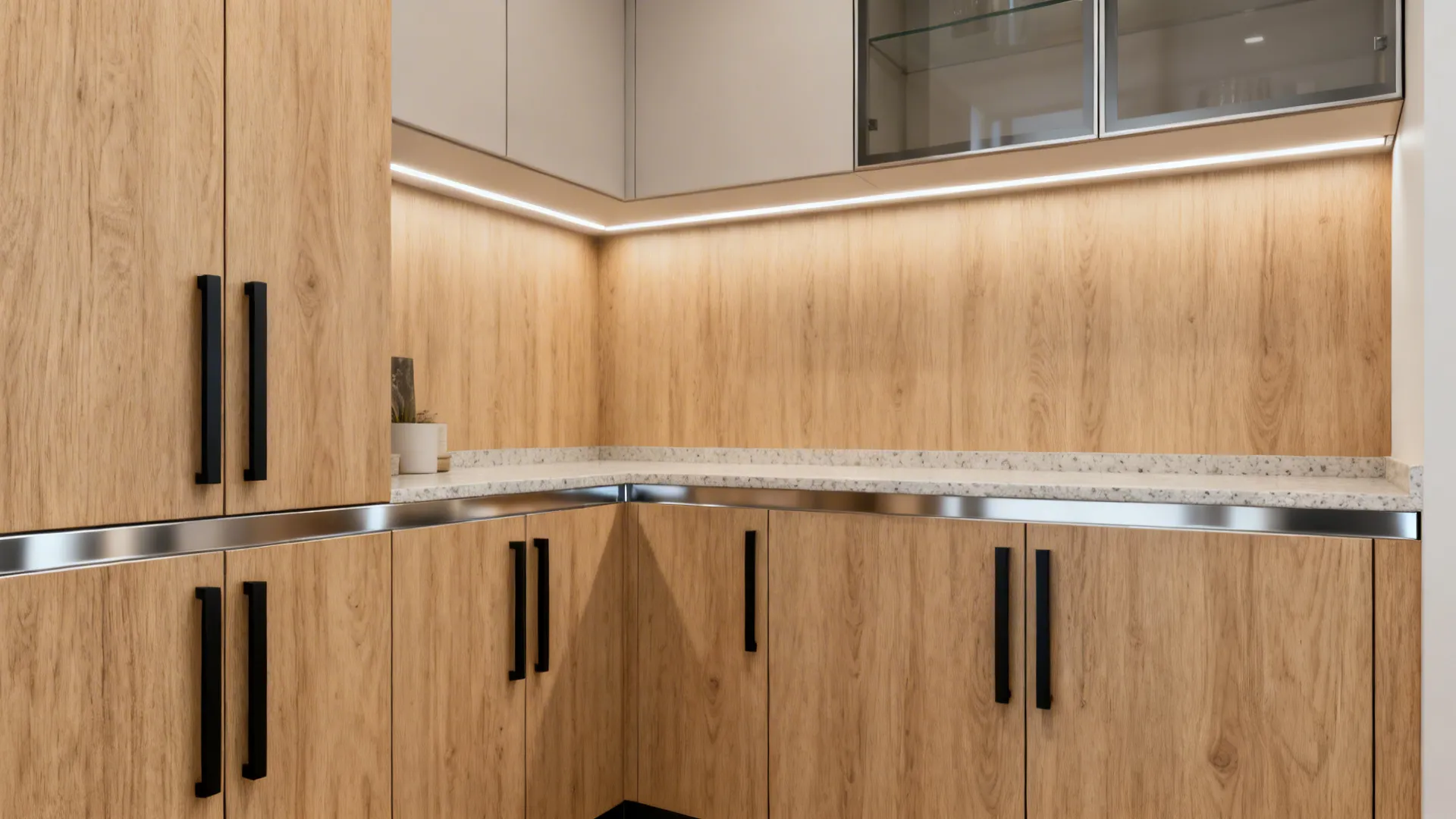 Modern kitchen corner featuring warm wood cabinets with matte black handles and bright LED lighting