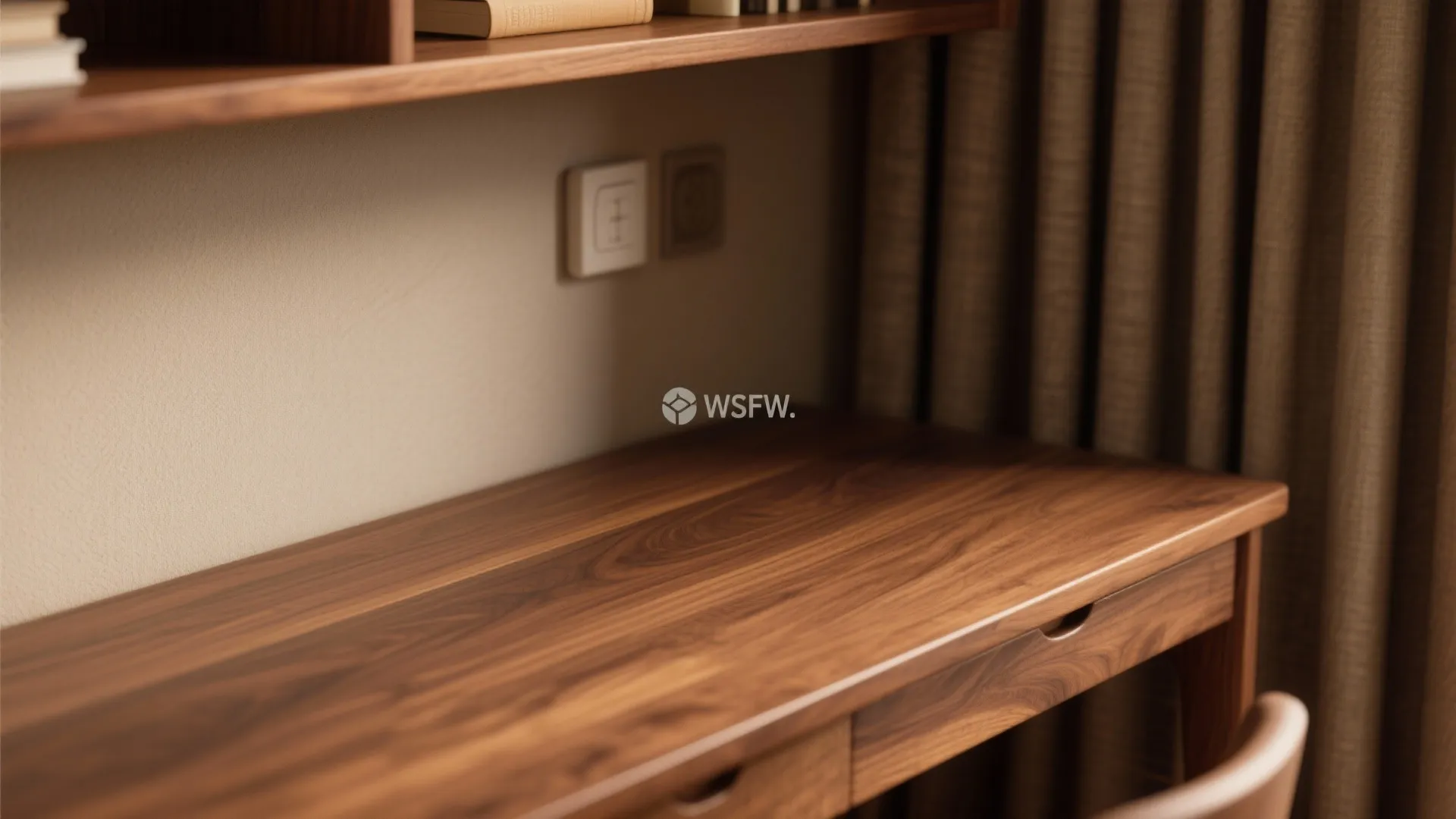 Close up of a dark wood desk surface with visible grain under a wall shelf
