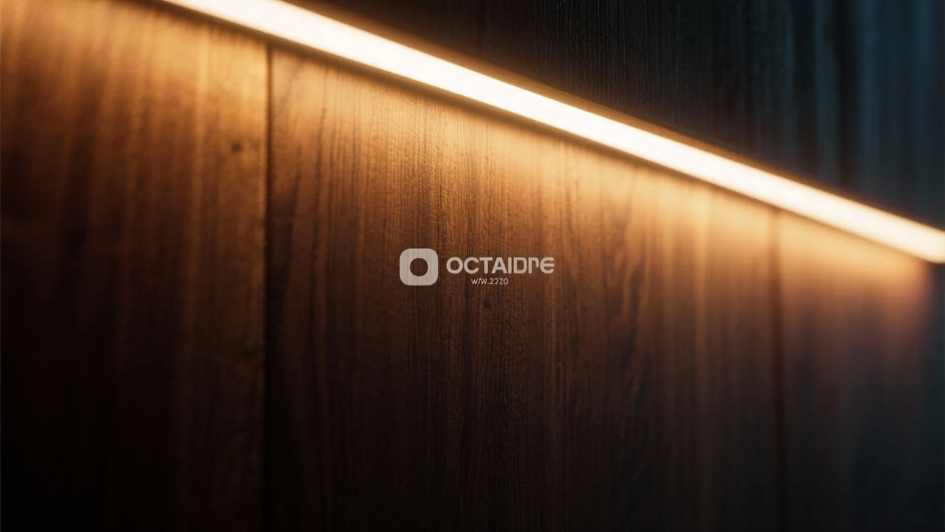Close up of dark wood wall panel with warm light strip glowing from hidden ledge