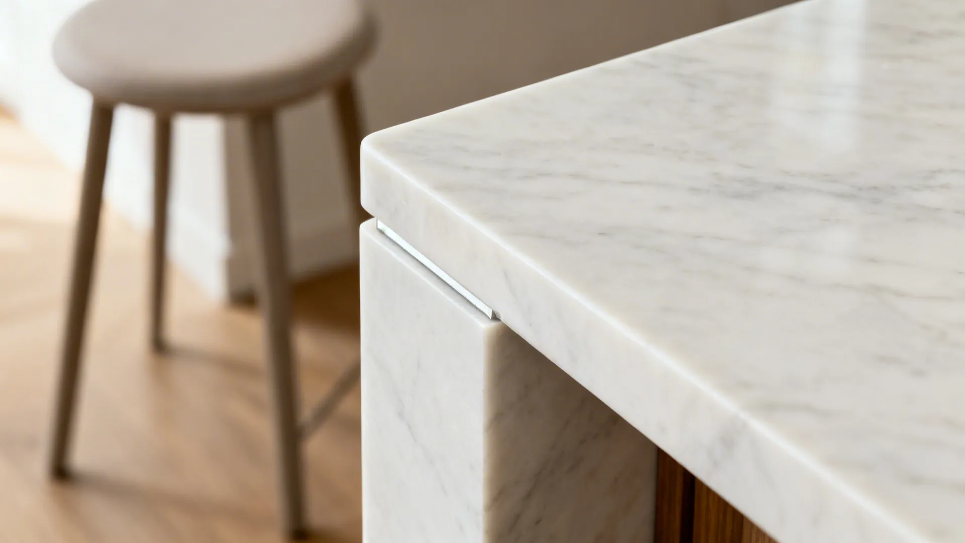 Macro view of a seamless white quartz waterfall edge with mitered corner detail.