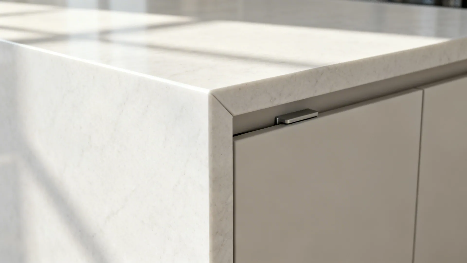 Macro view of a quartz waterfall edge with eased corner and concealed door seam.