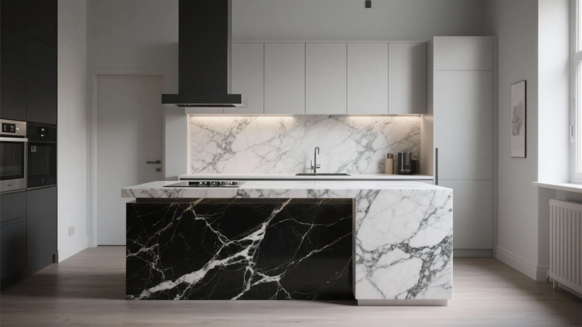 Modern kitchen with black and white marble island and white cabinets under a black hood