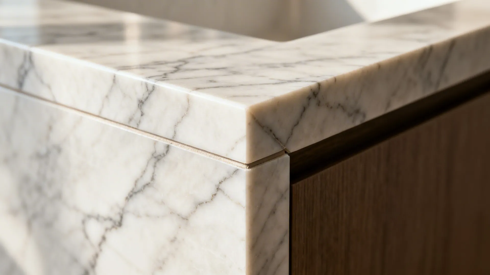 Macro of a quartz mitered waterfall joint with precisely matched veining and a tight seam.