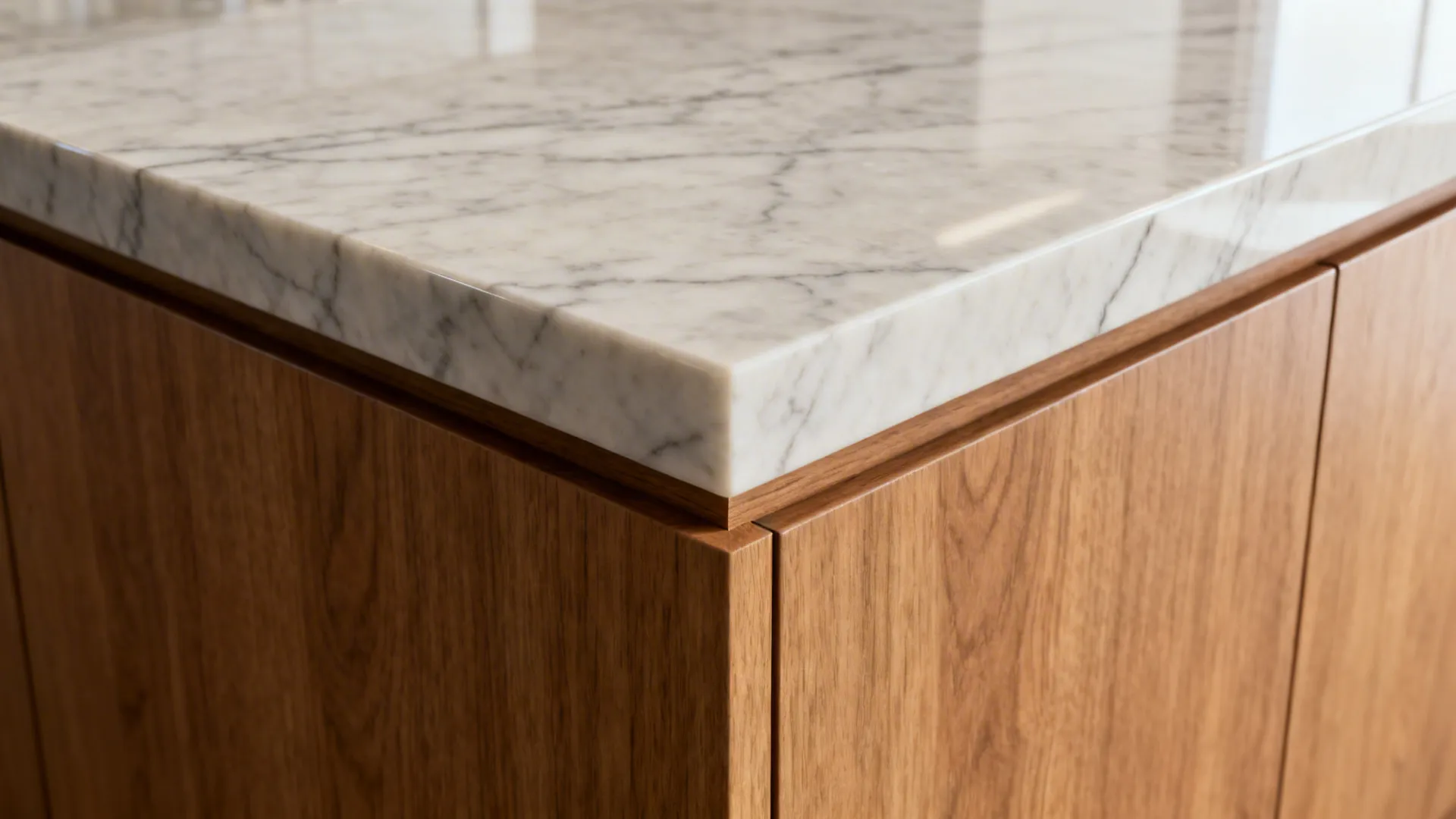 Close-up of a quartz waterfall corner with a tight miter and aligned veining over oak.
