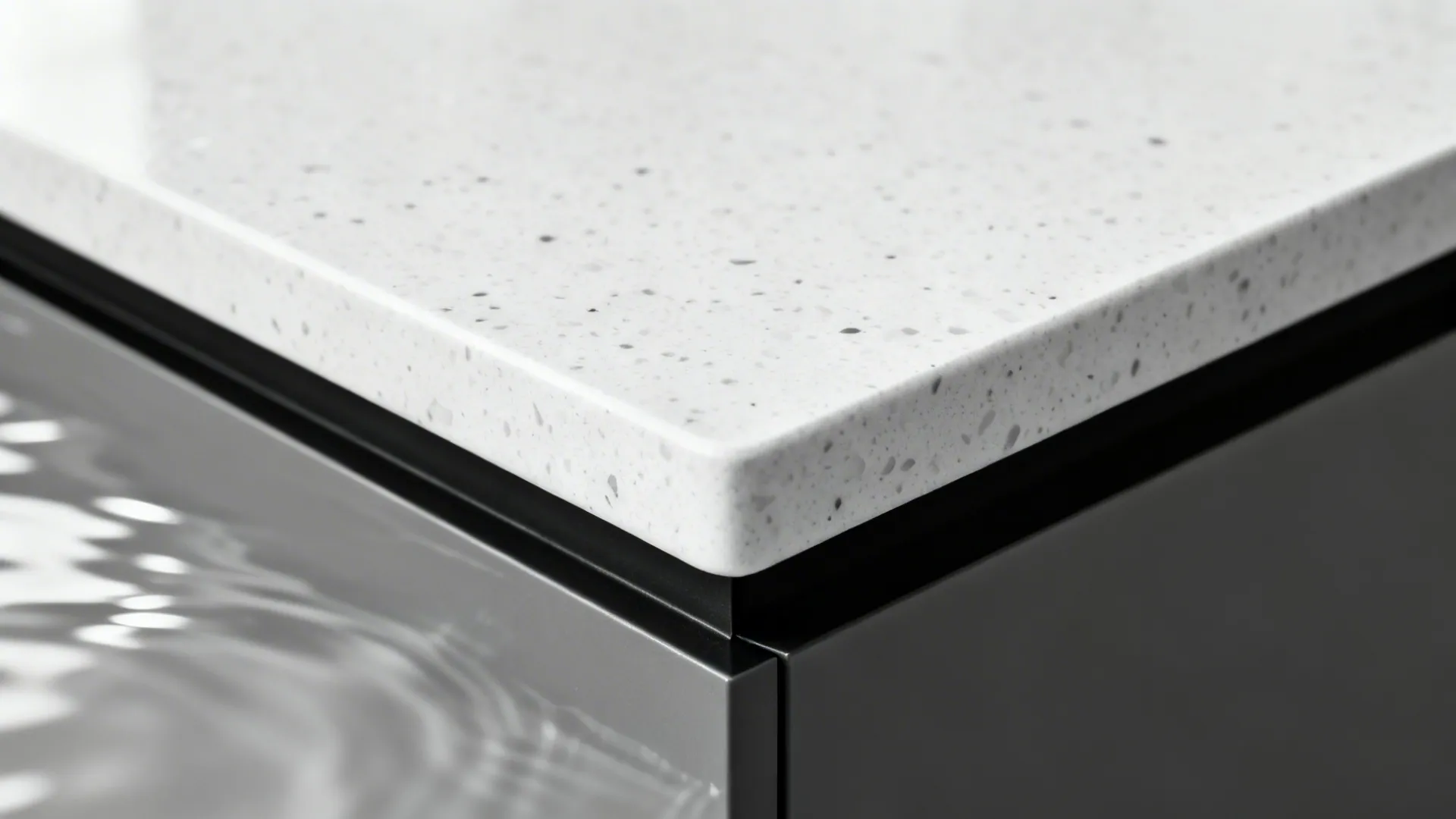 Macro of eased stone edge with a thin black band and a crisp mitered waterfall corner.