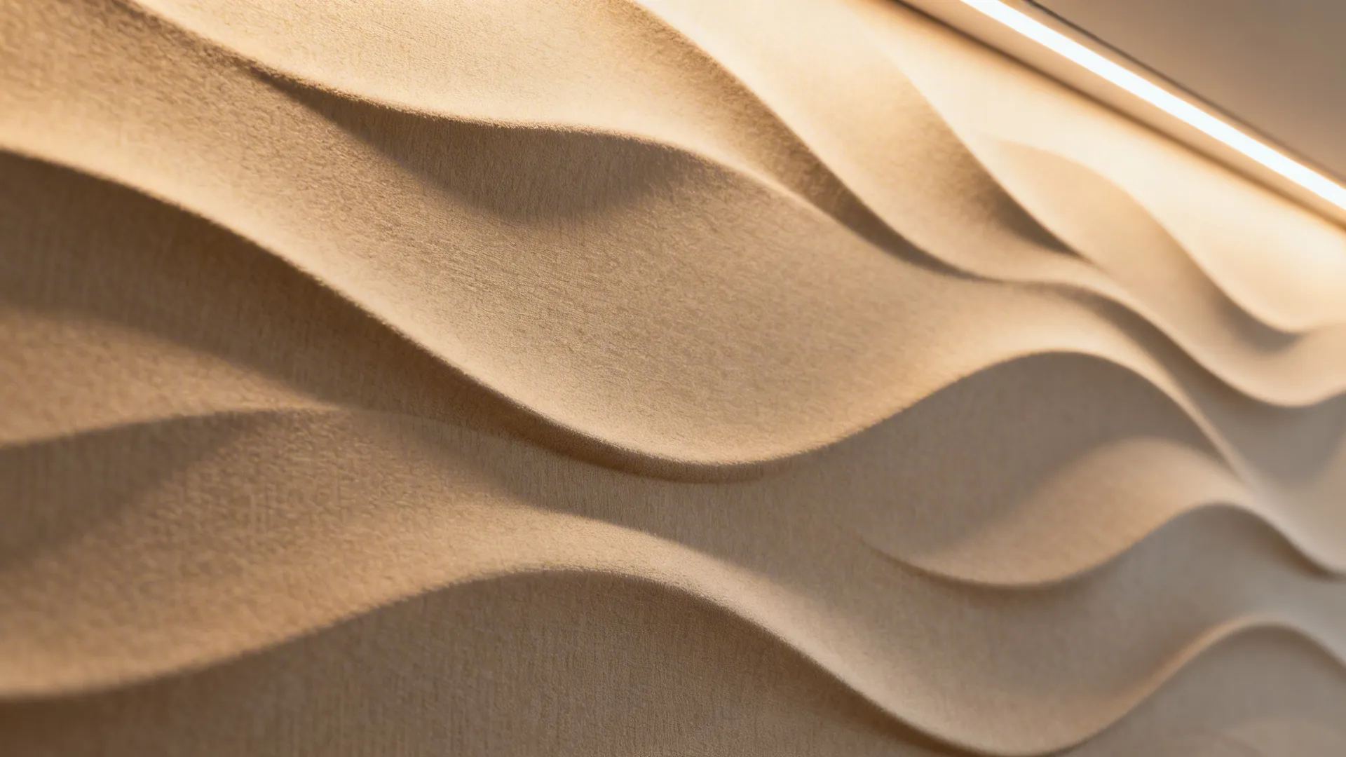 Macro of greige 3D wave wallpaper with warm grazed light on curved ridges.