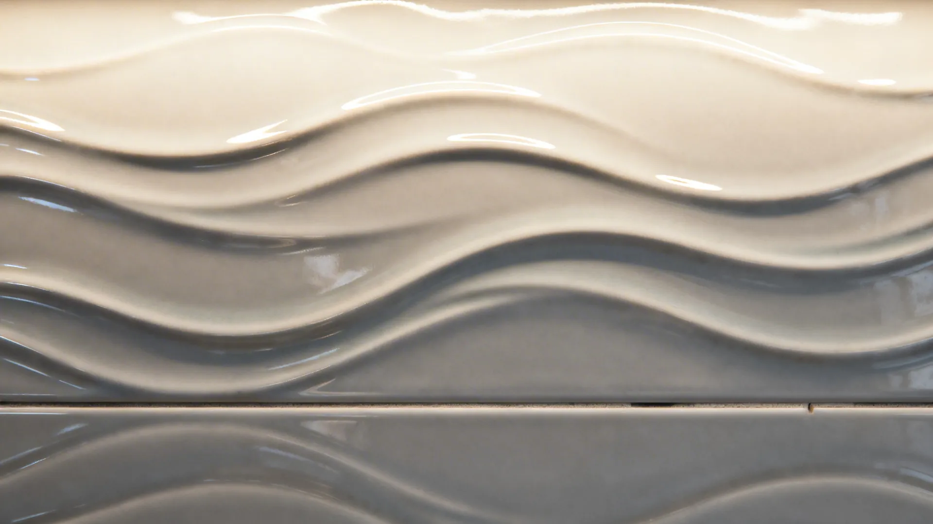 Macro of wave-textured porcelain panel with soft highlights and shadows.