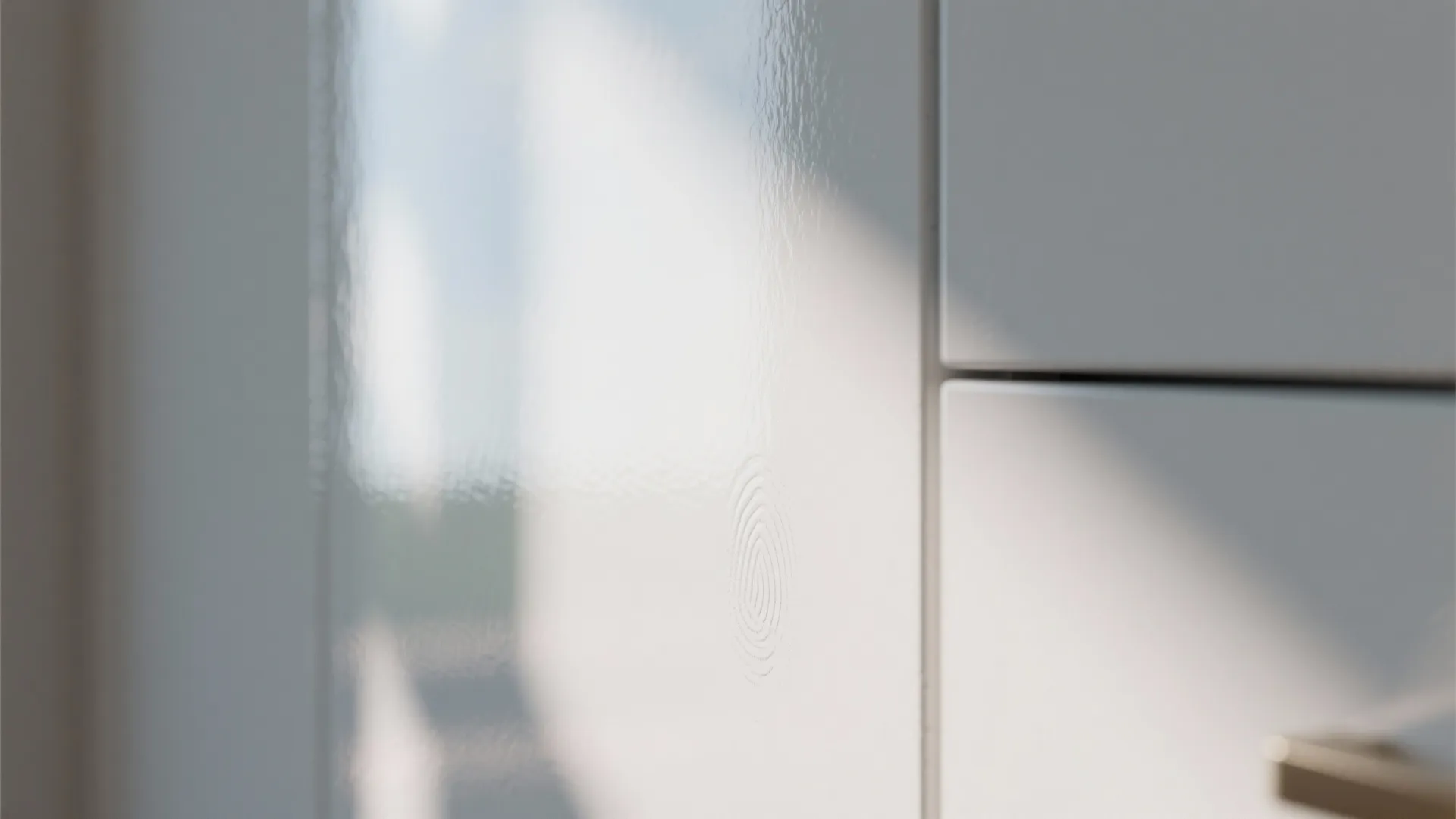 Close up of shiny white kitchen cabinet surface with light reflection and clean modern finish