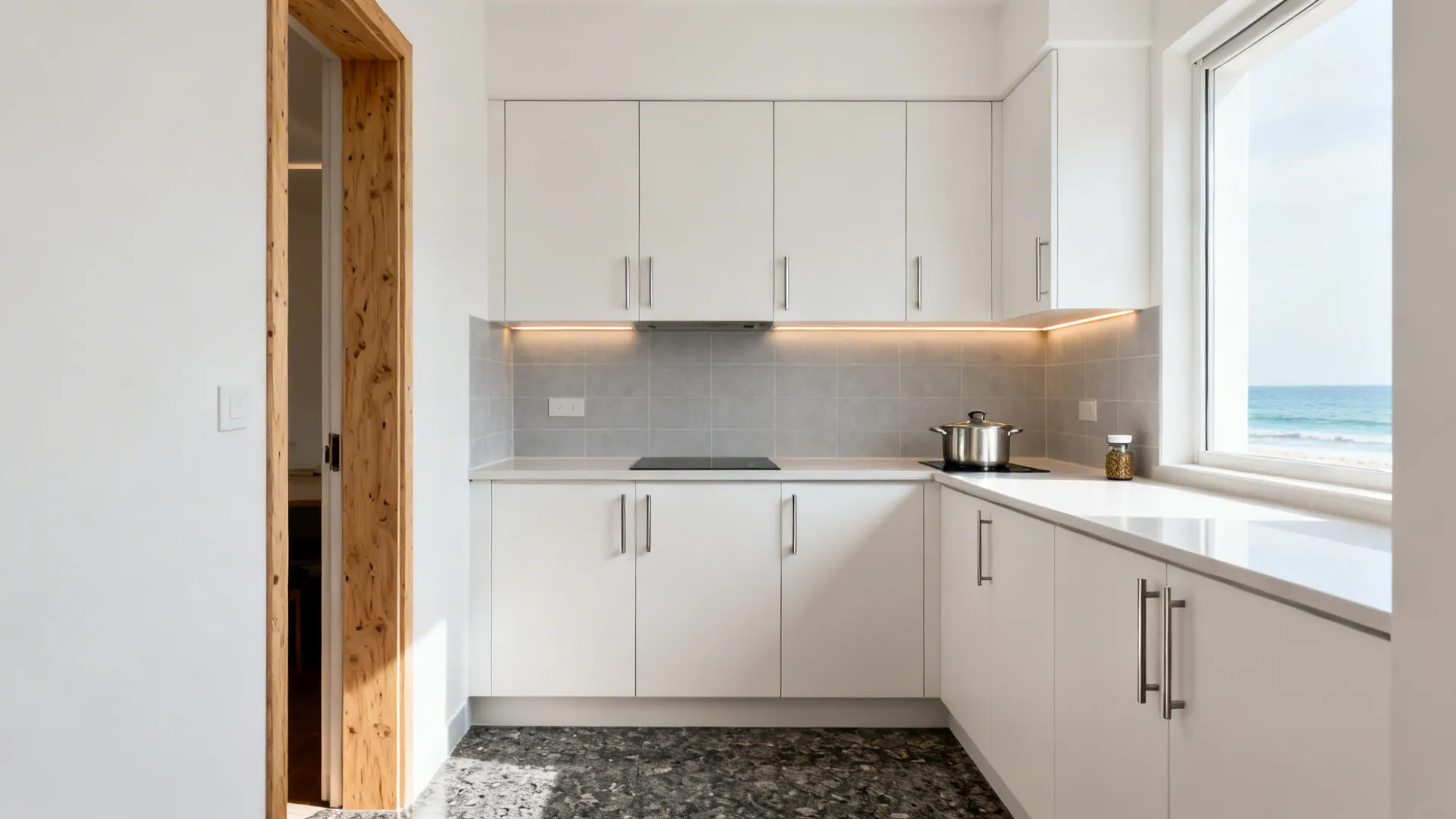 Matte white laminate cabinets with stainless pulls brighten a compact Kerala kitchen.