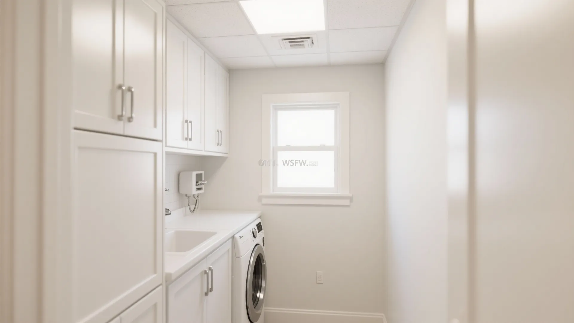 Small white laundry room design with white cabinets washing machine sink window and bright lighting