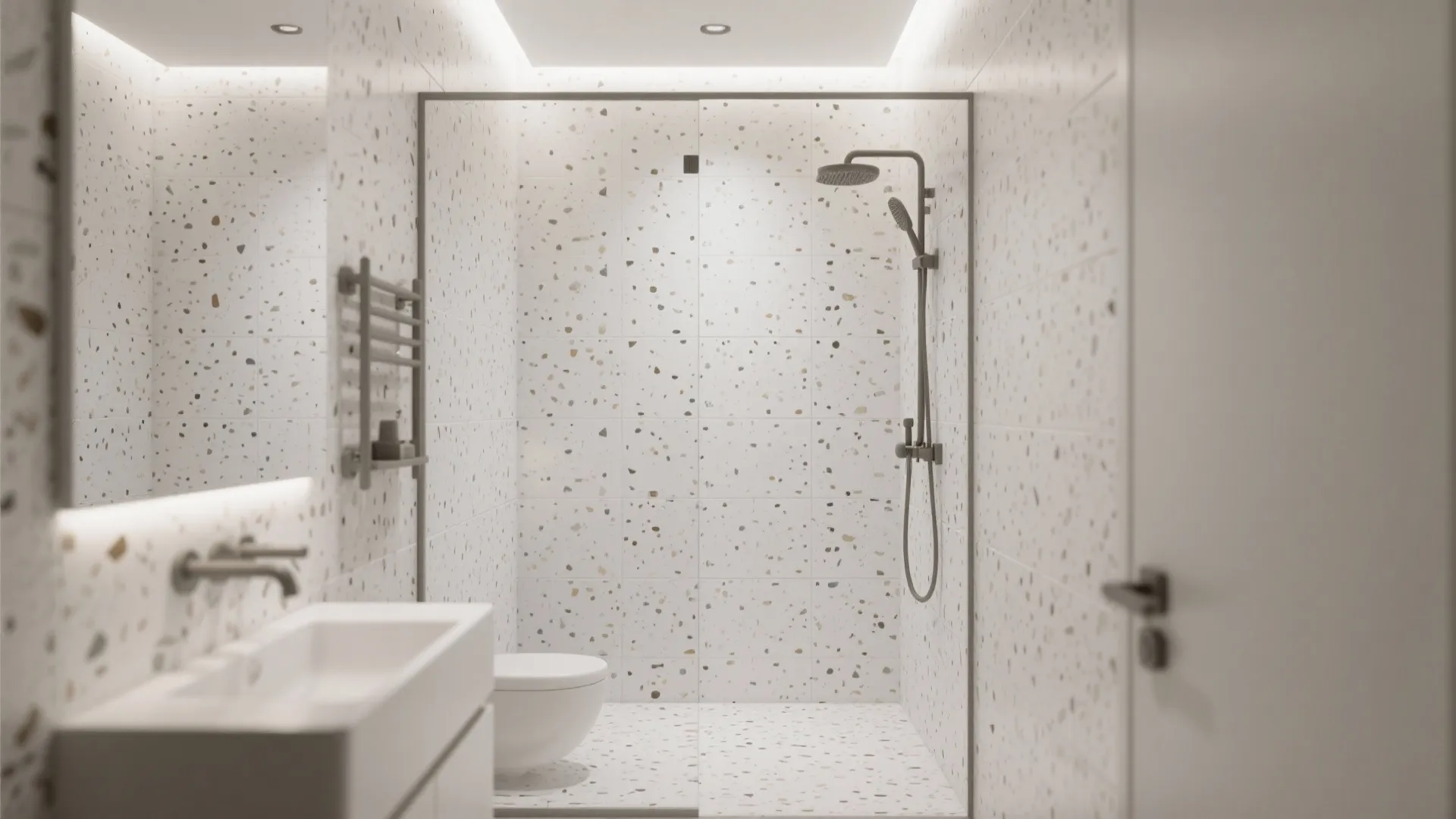 Minimalist bathroom interior featuring white terrazzo wall tiles with sink and glass walk-in shower area
