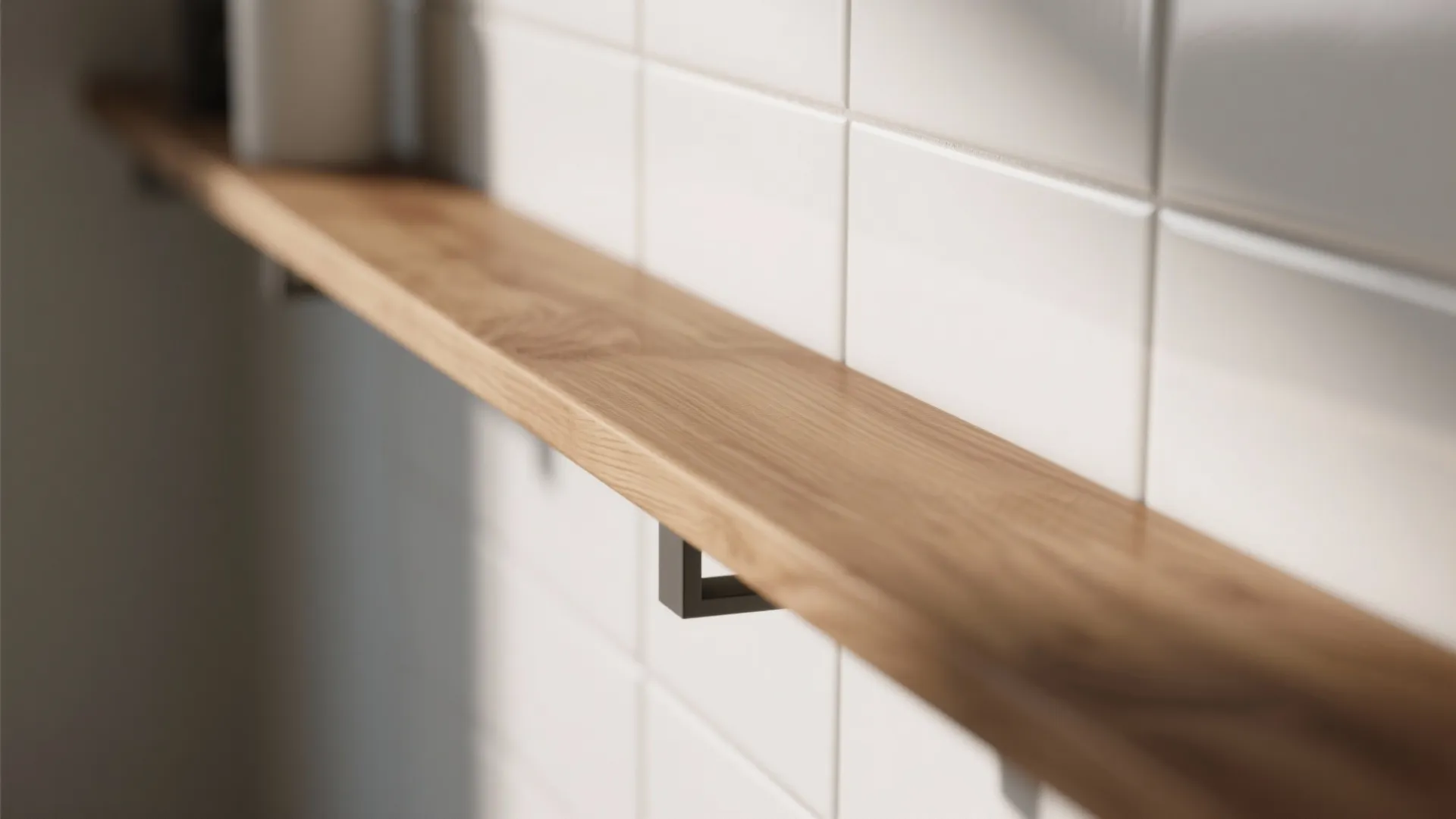 Long wooden shelf mounted on a white square tiled wall with small black metal brackets
