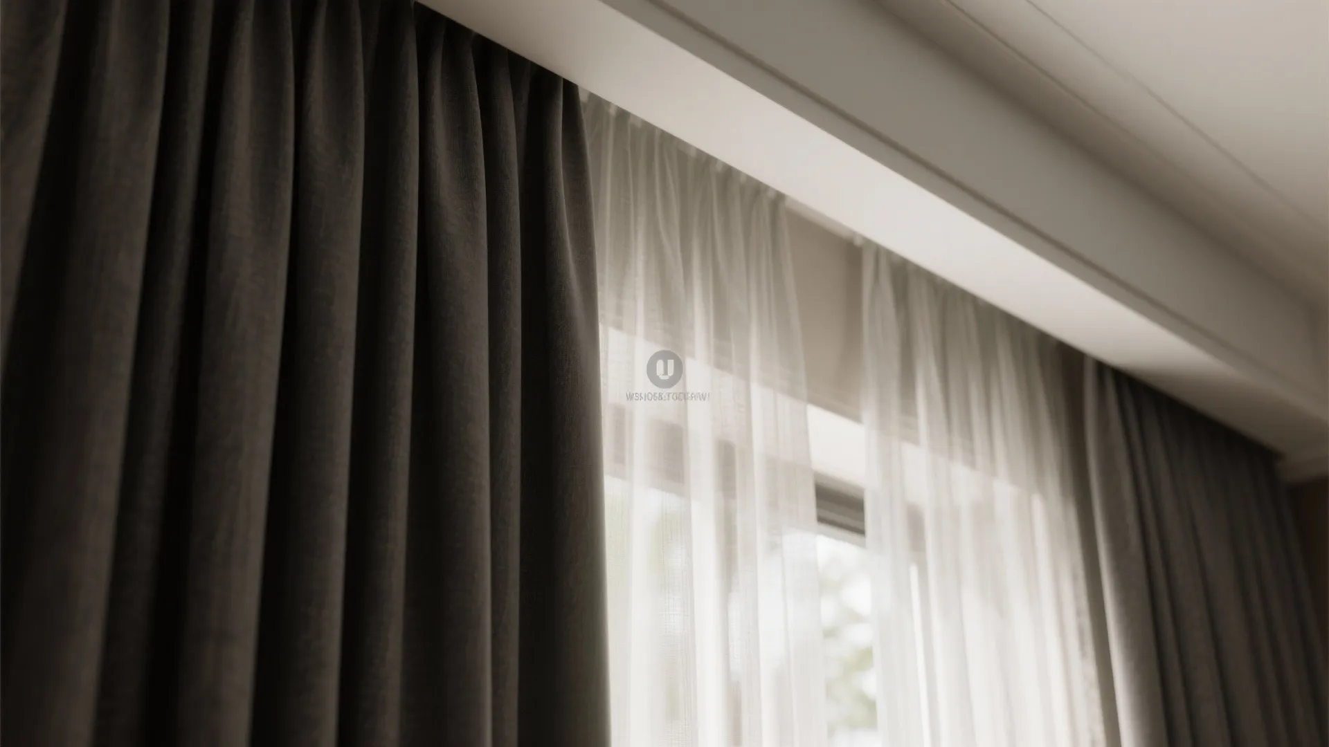 Close up of dark grey curtain and white sheer curtain hanging over windows in modern room