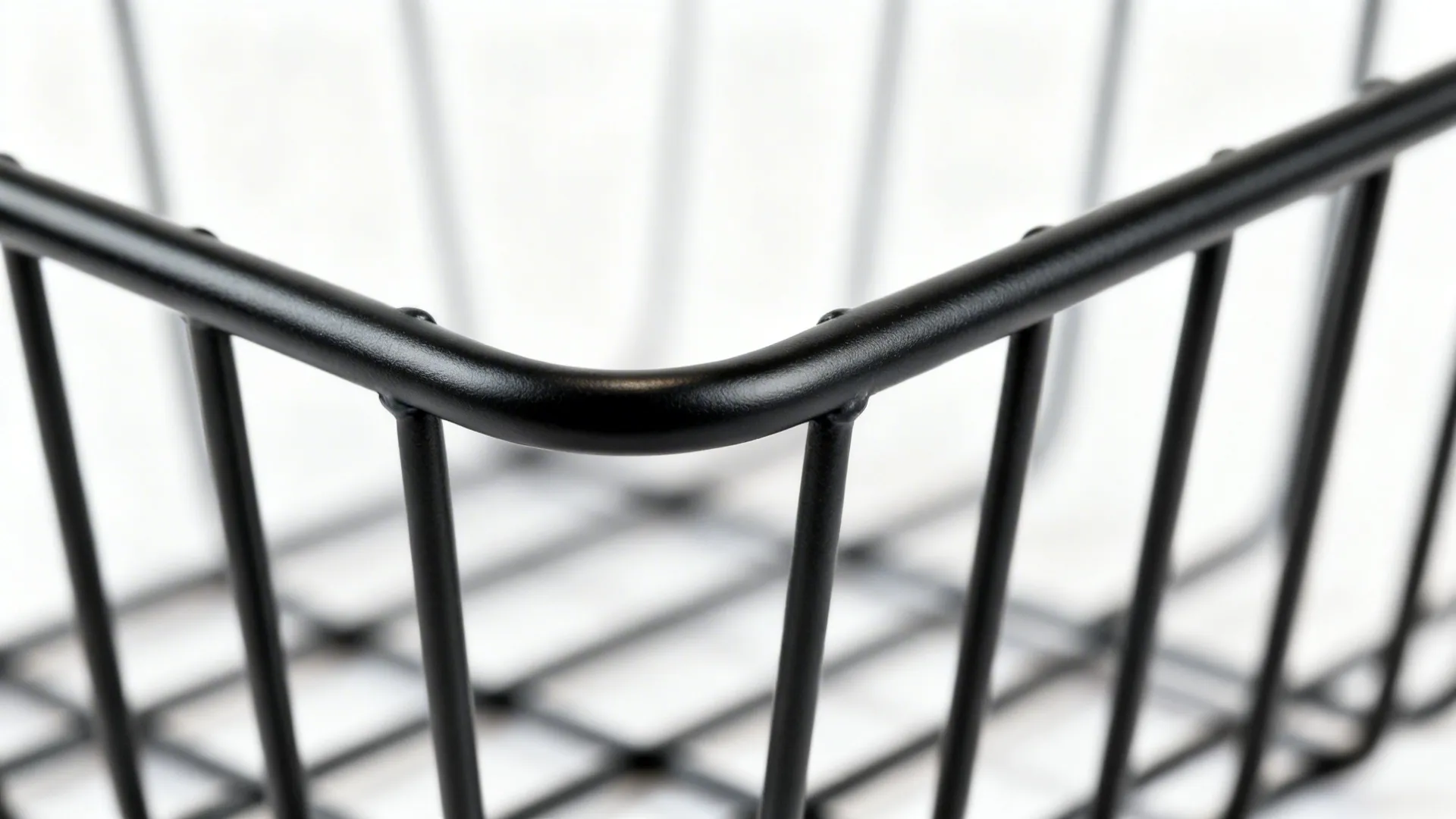 Macro of a matte powder-coated wire basket joint with precise detailing.