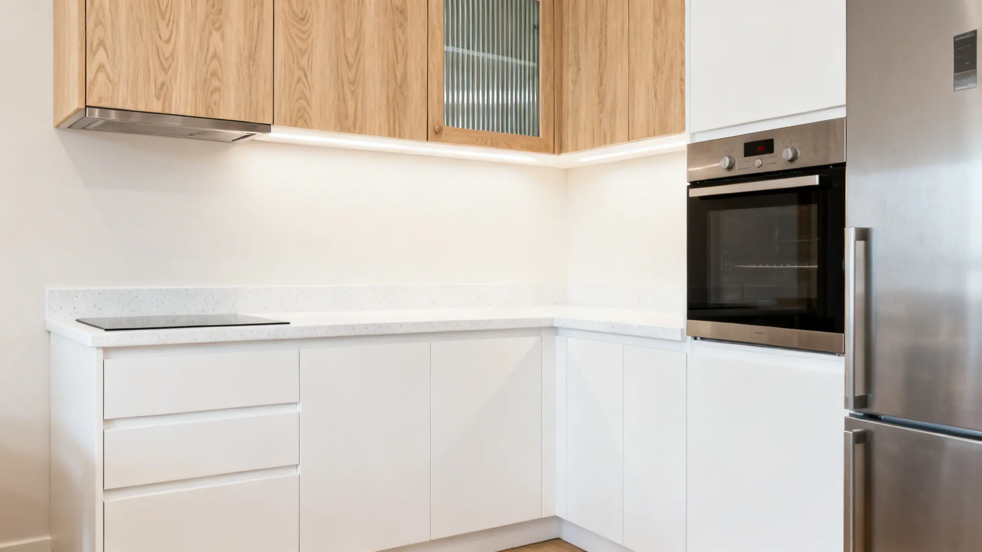6x8 kitchen with matte white bases and light oak-look upper cabinets for added warmth.