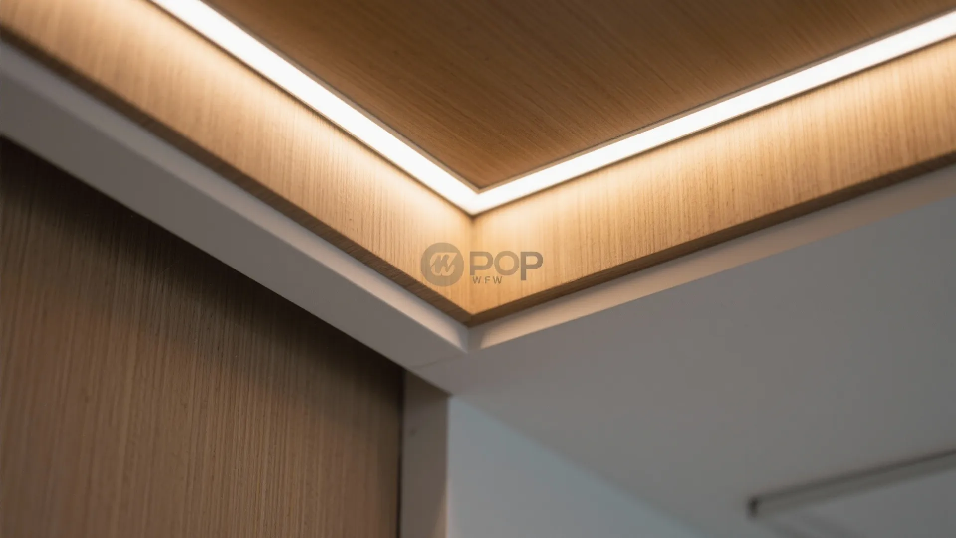 Close up of wood wall panel with warm light strip installed in a modern corner ceiling
