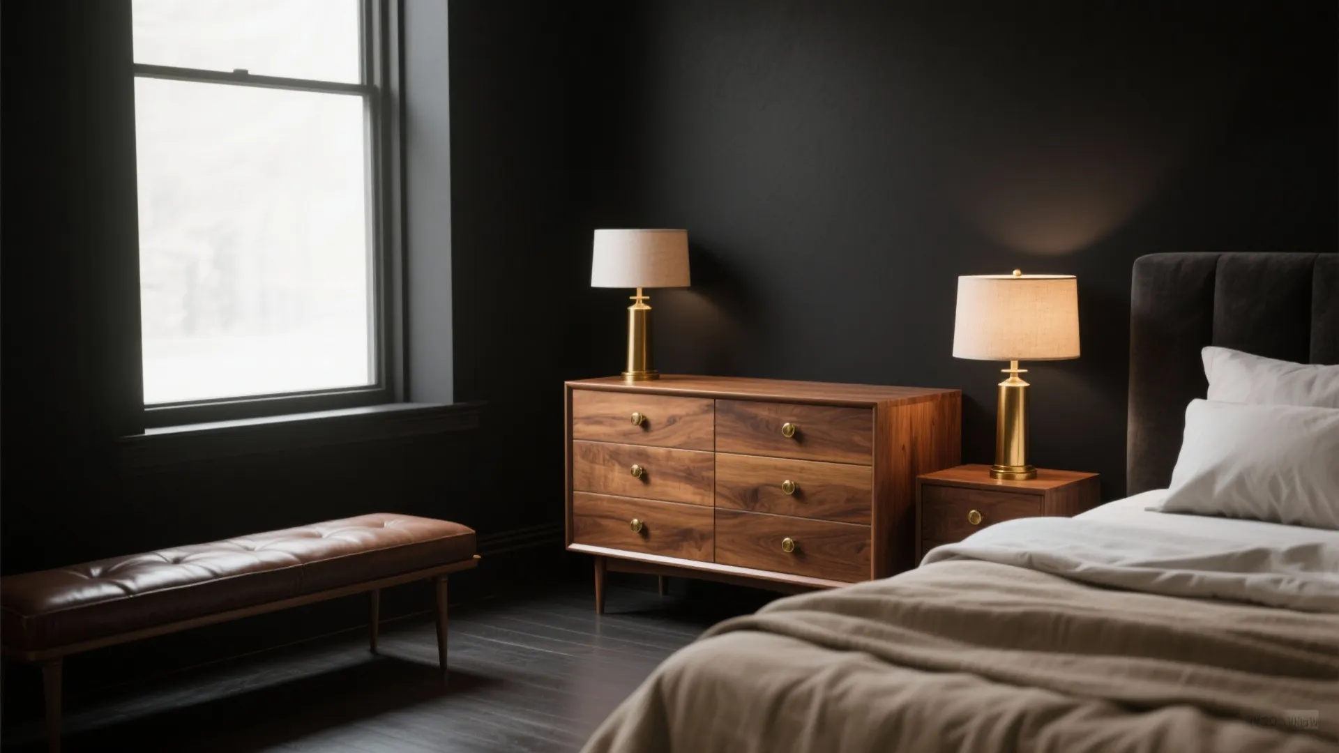 Bedroom with dark walls wooden cabinet brass table lamps leather seat and a large window