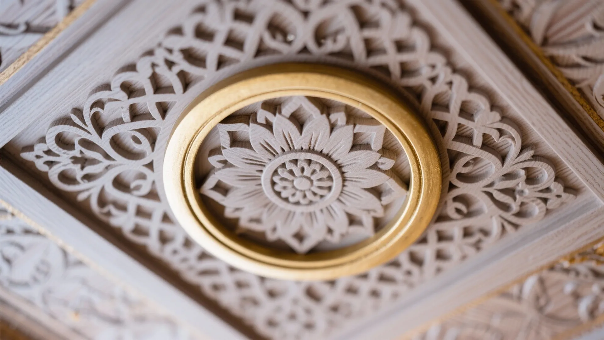 Detailed carved wood wall panel with a flower pattern inside a gold circular frame decoration