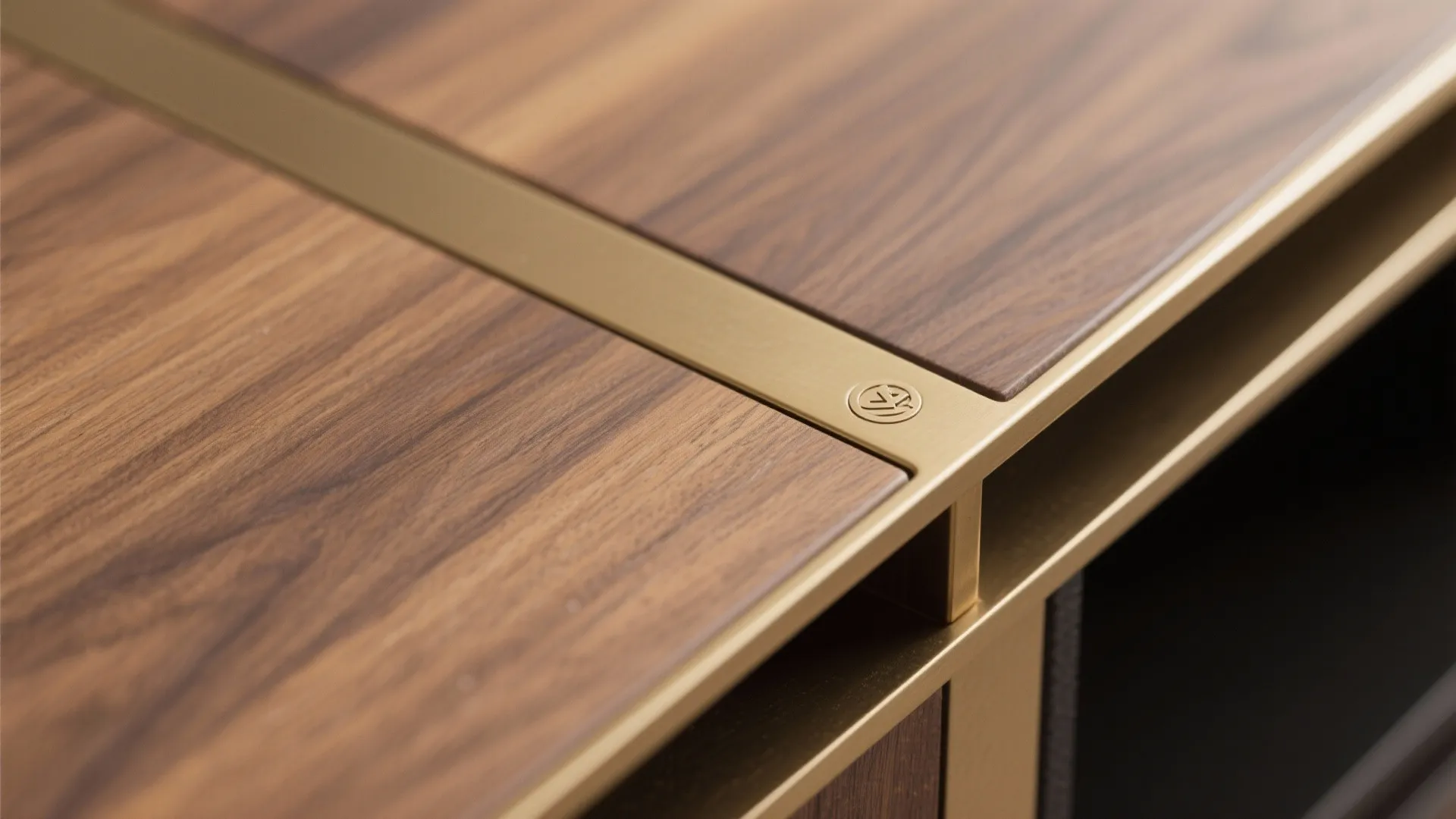 Dark wood surface with gold metal trim and a small round logo in the corner