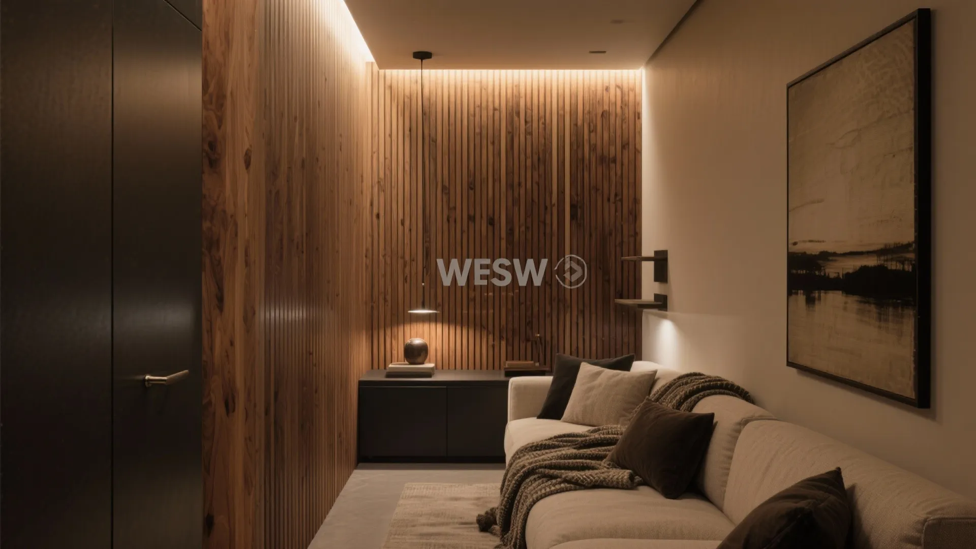 Cozy living space with vertical wood wall panel and warm light fixture above a grey sofa