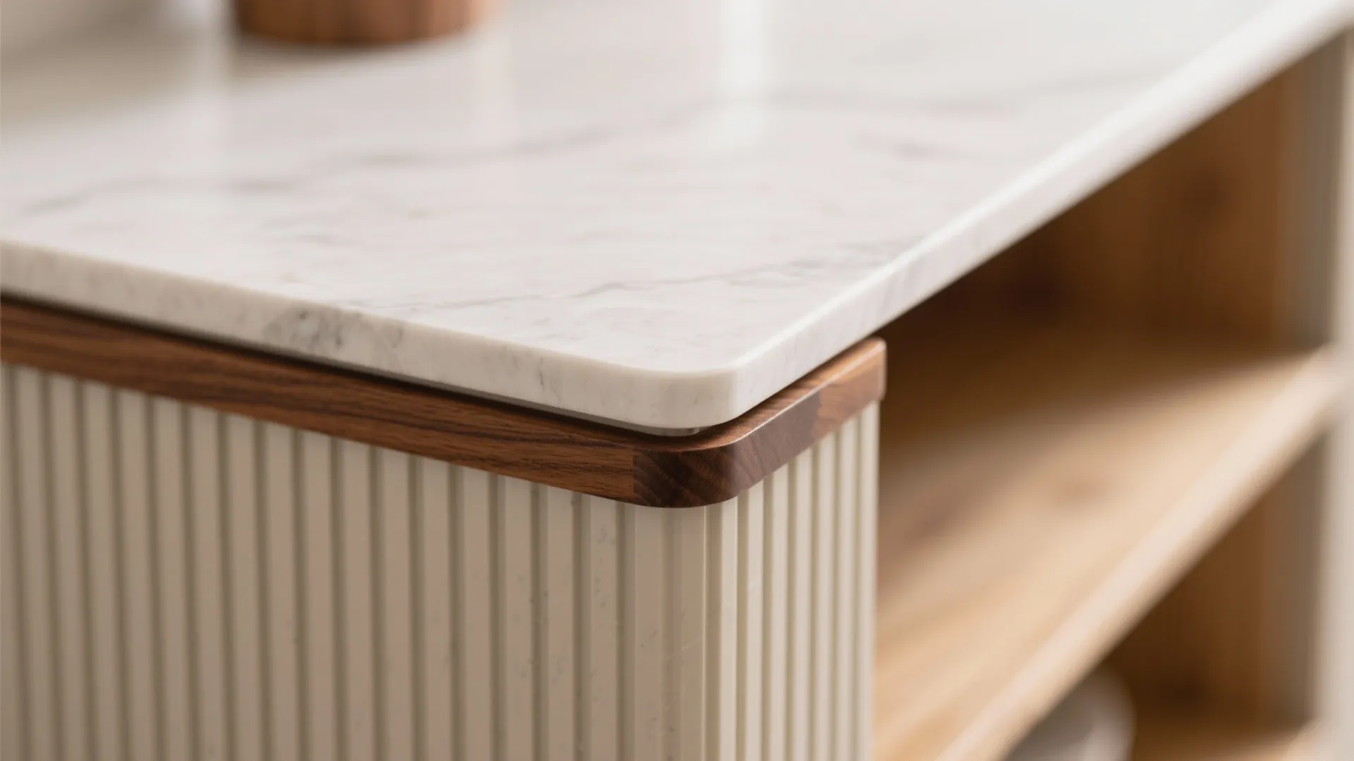 Close up of white marble cabinet top with brown wood edge and vertical white wall panel