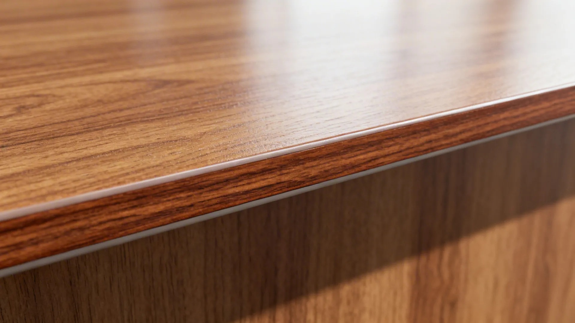 Macro of oak-look laminate edge and sealed narra wood bar surface.