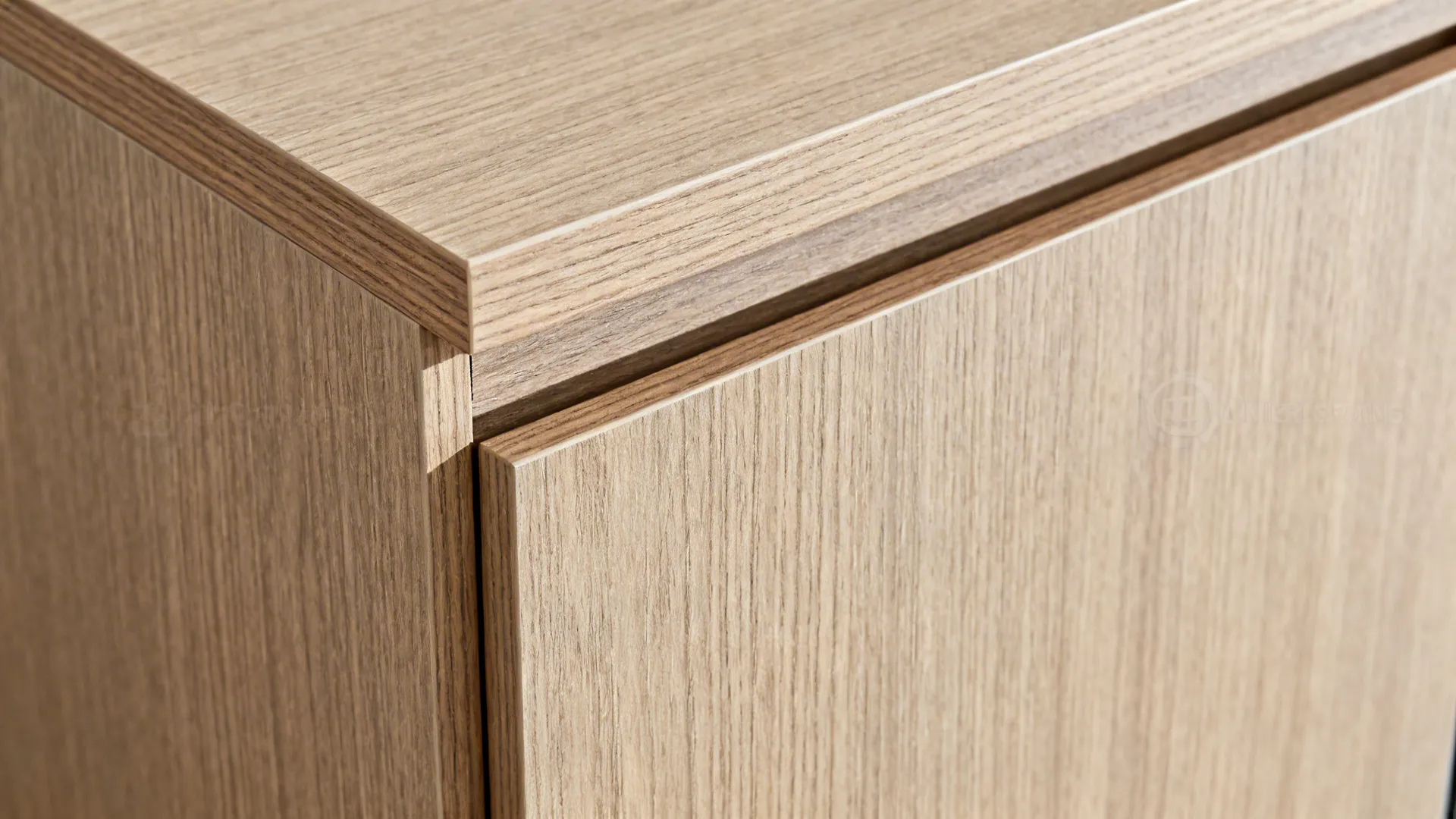 Close-up of aligned wood-look laminate grain beside a panel-ready compact appliance.
