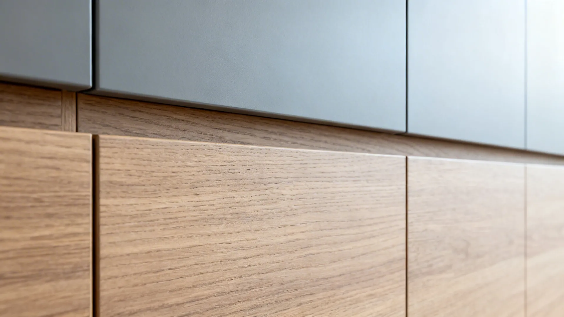 Macro of matte wood grain and soft-matte grey mica cabinet finishes with clean edge-banding.