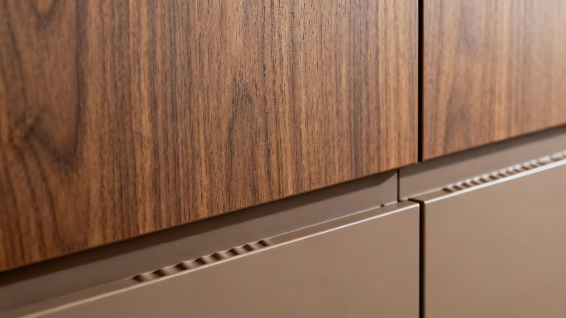 Close-up of walnut-textured laminate grain beside a matte taupe cabinet finish.