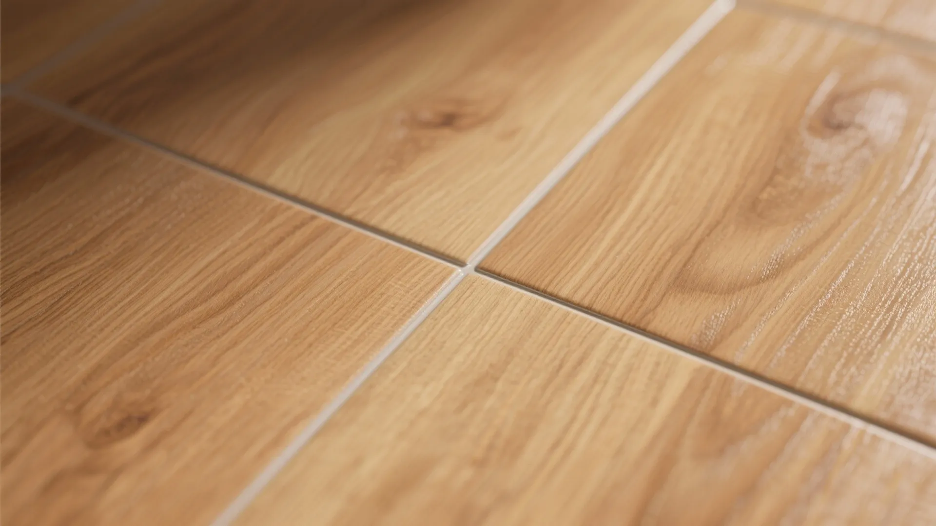Close up view of light brown wood floor tiles showing natural grain and white grout