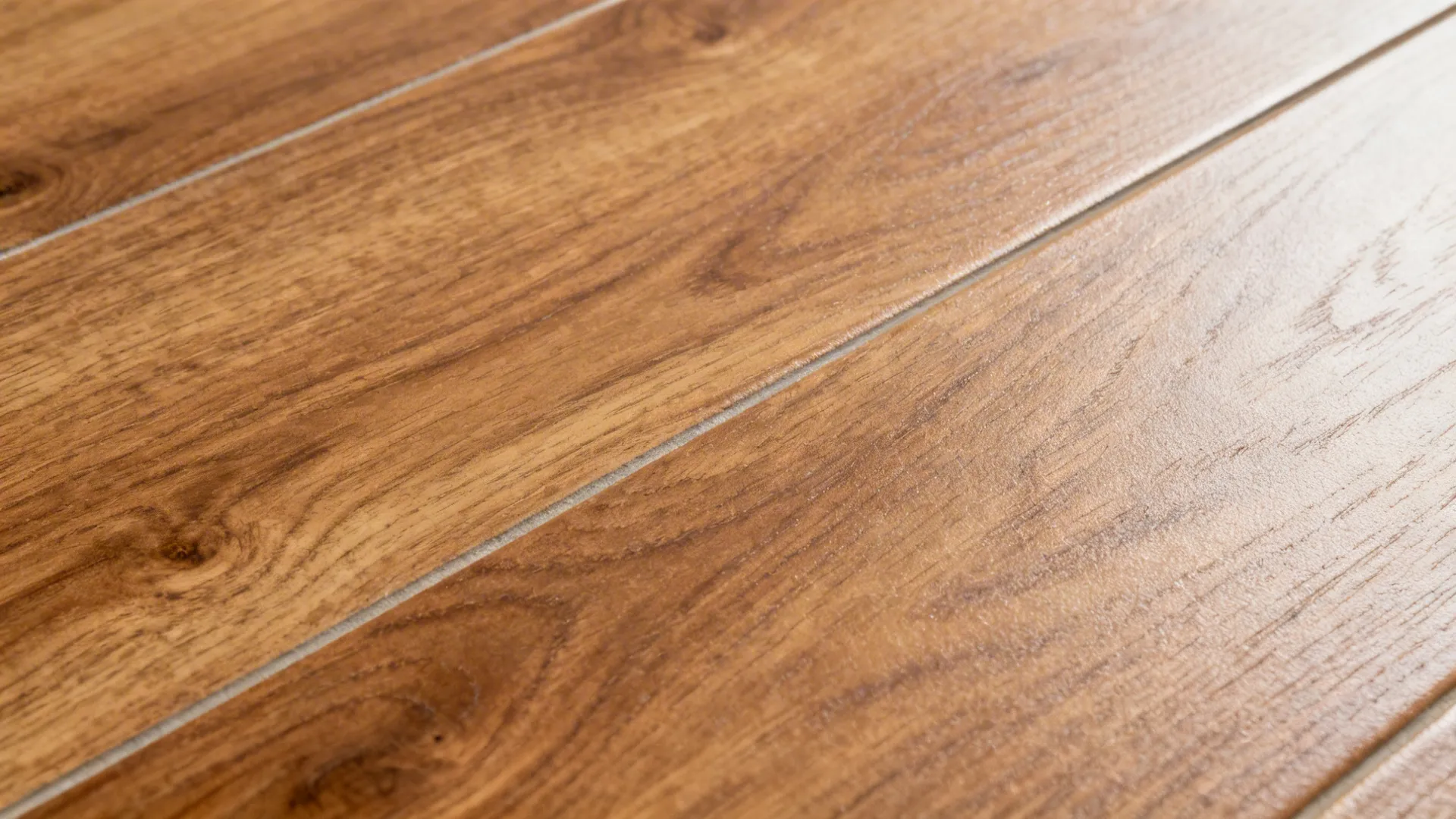 Brown wood floor planks showing natural grain patterns and a smooth glossy surface for interior design