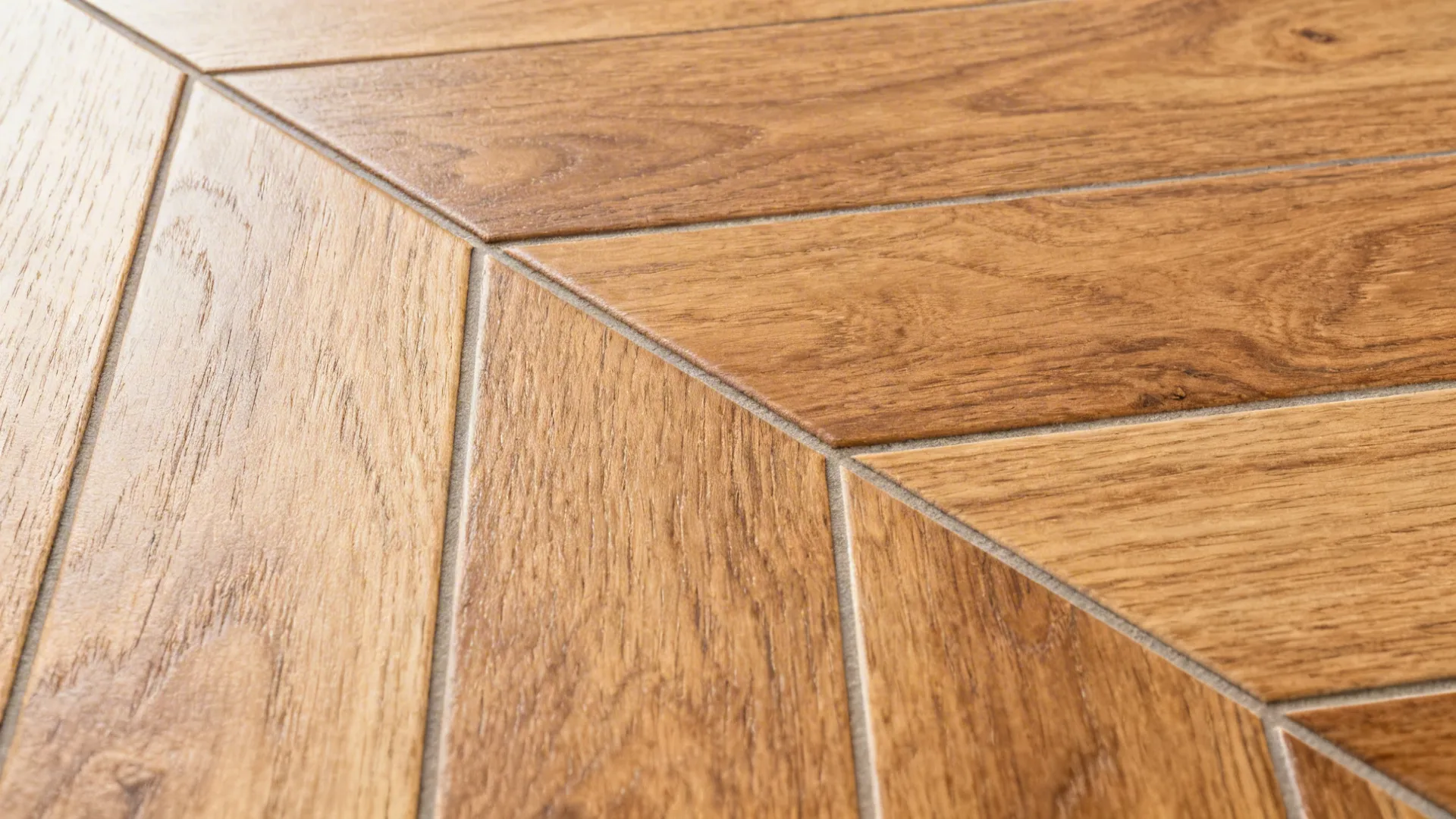 Macro of wood-look porcelain plank with subtle bevel and tight color-matched joint.
