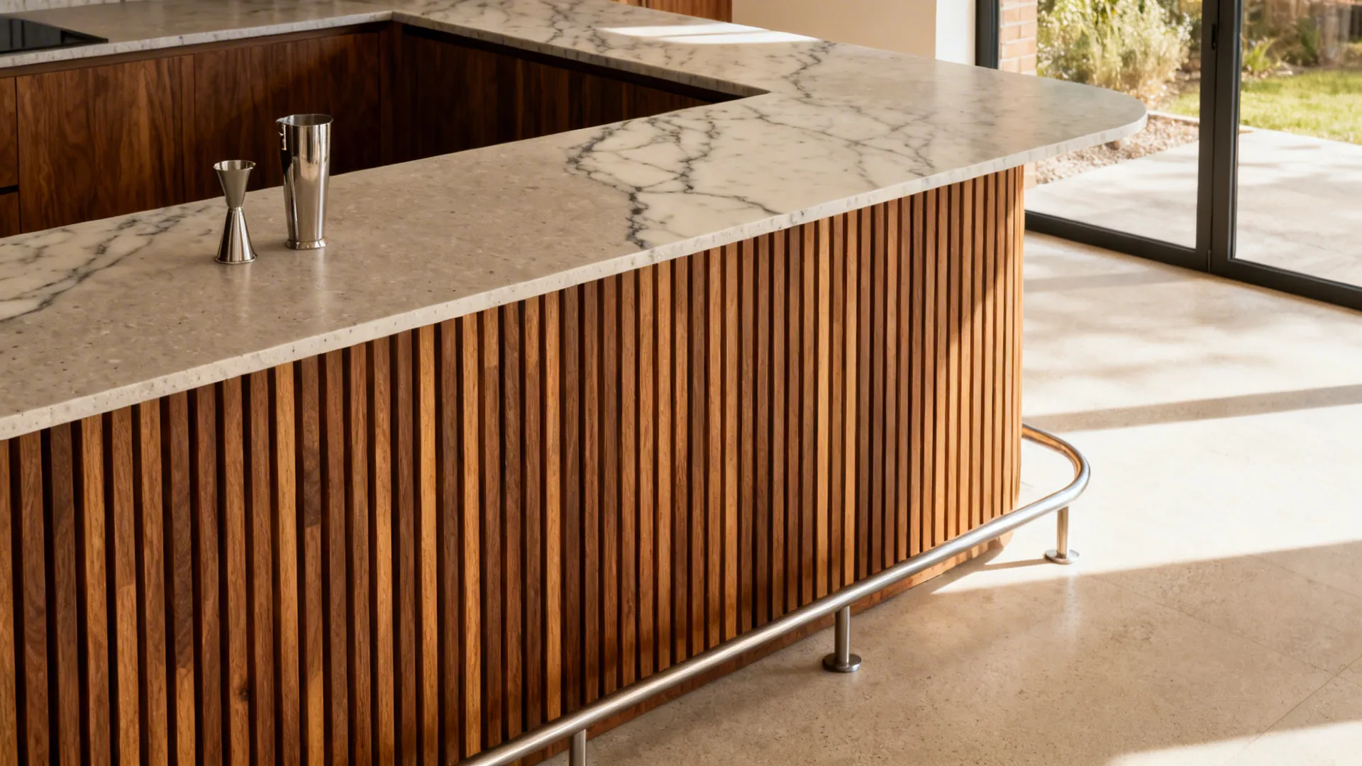 Kitchen bar with slatted oak front and a matte quartz countertop in warm natural light.