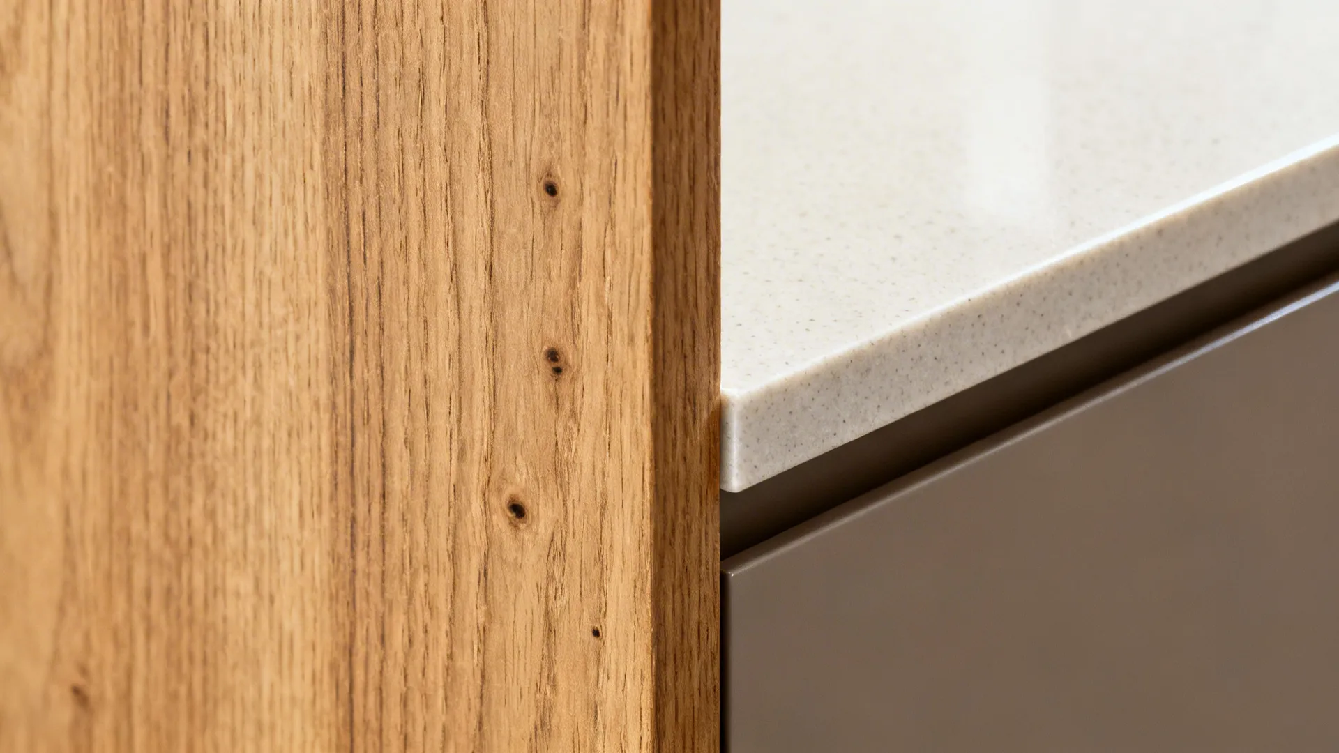 Close-up of rift oak veneer beside honed quartz, showing straight grain and sealed edge.