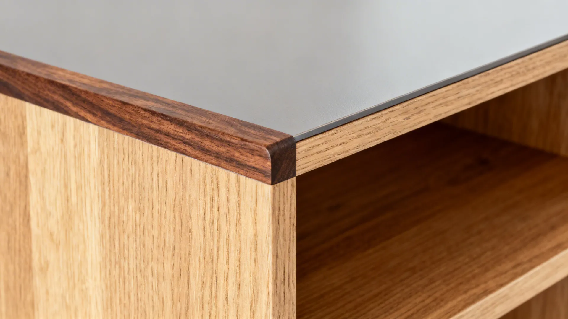 Macro of walnut trim and rift oak shelf with satin water-resistant finish showing rich grain.
