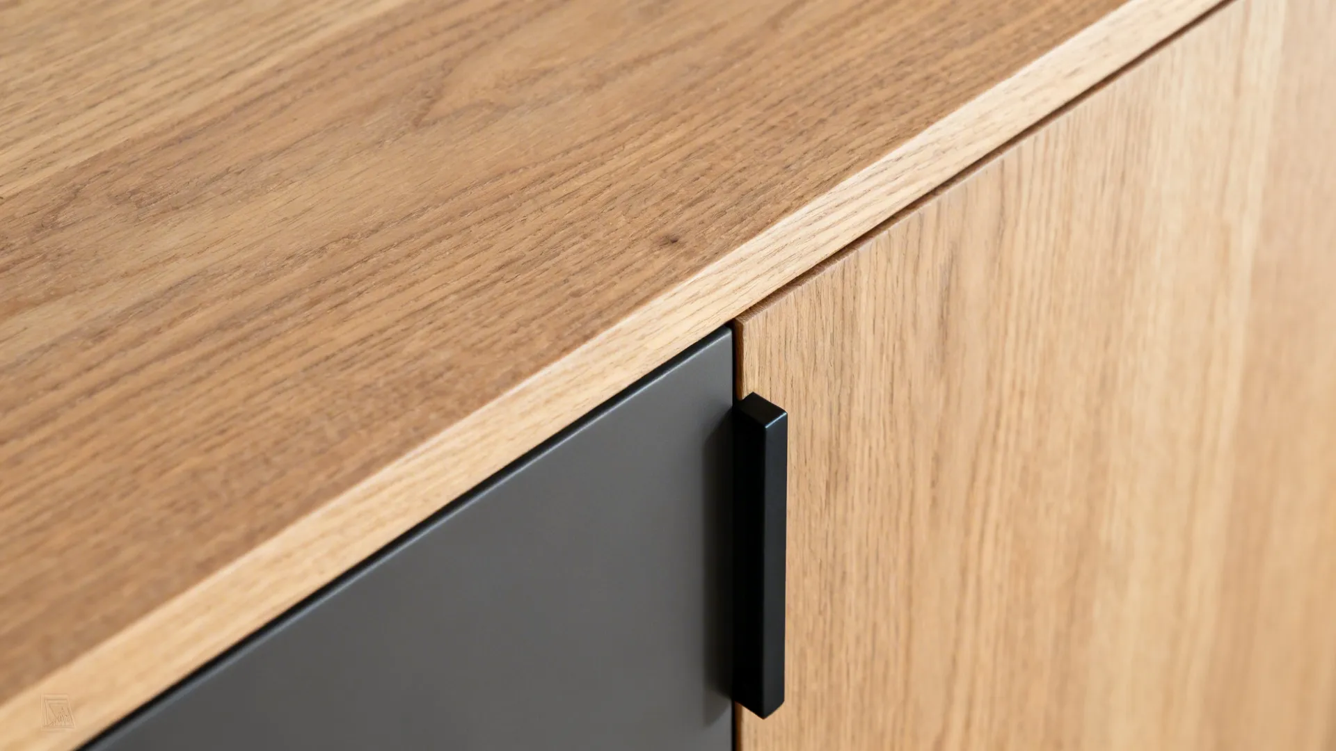 Macro of rift-cut oak veneer, matte cabinet finish, and slim black pull detail.