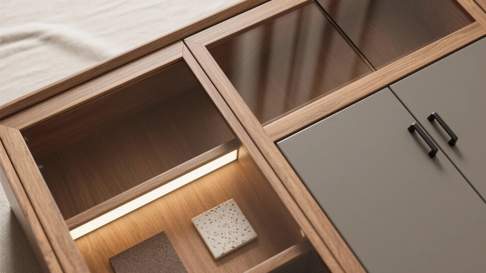 Wooden storage cabinet featuring glass top panels with light fixture inside and modern grey door