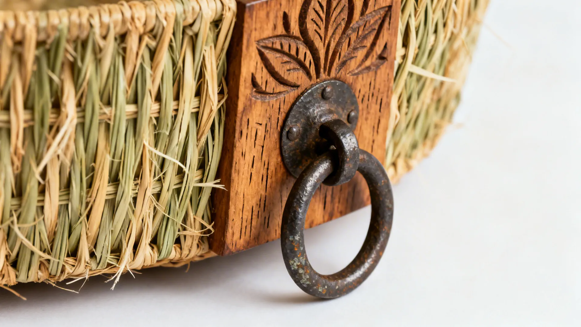 Macro of woven fibers, carved wood, and iron patina showing rich tactile detail.