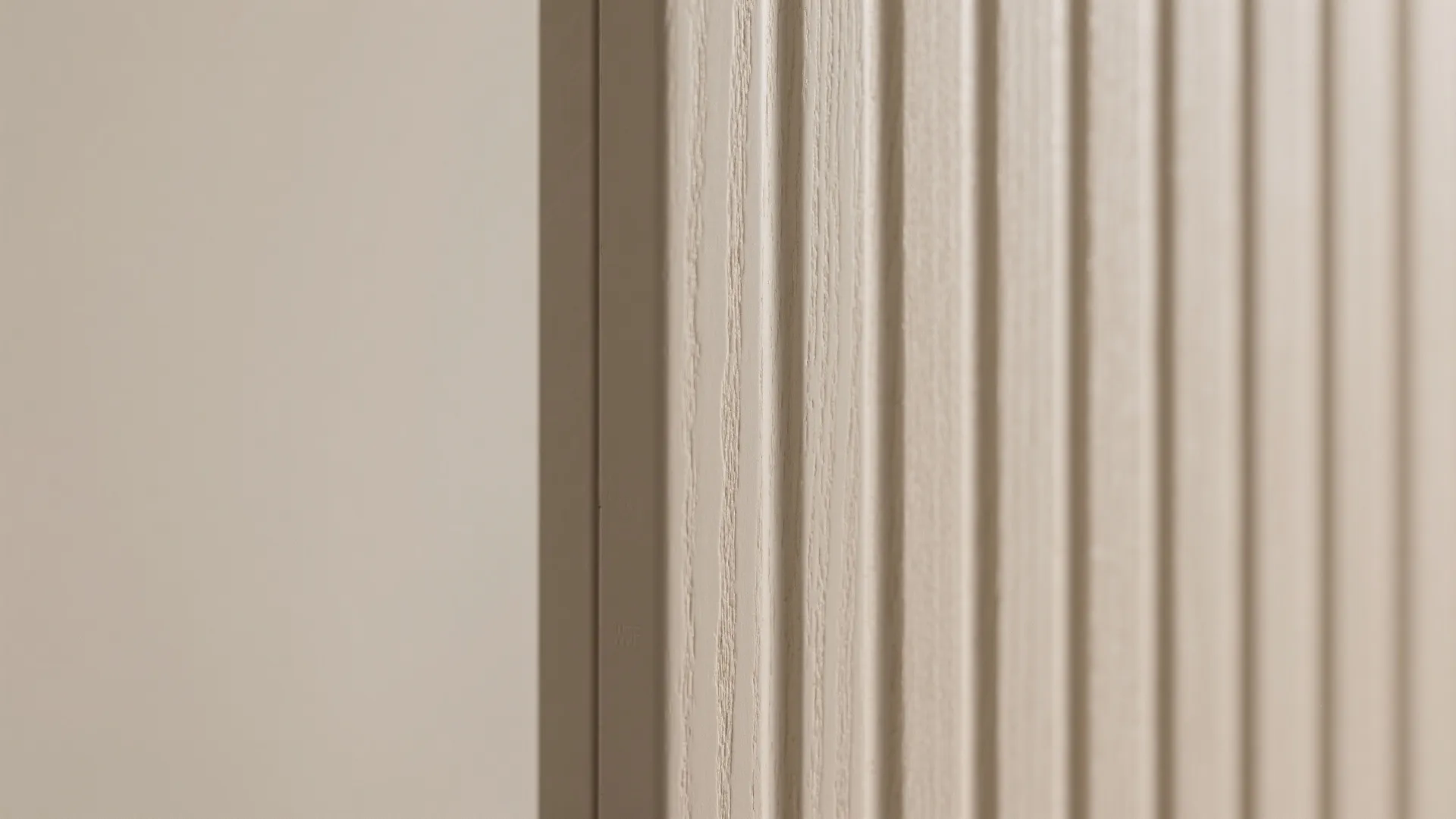 Macro view of beige wall panel with vertical lines showing texture and clean modern design